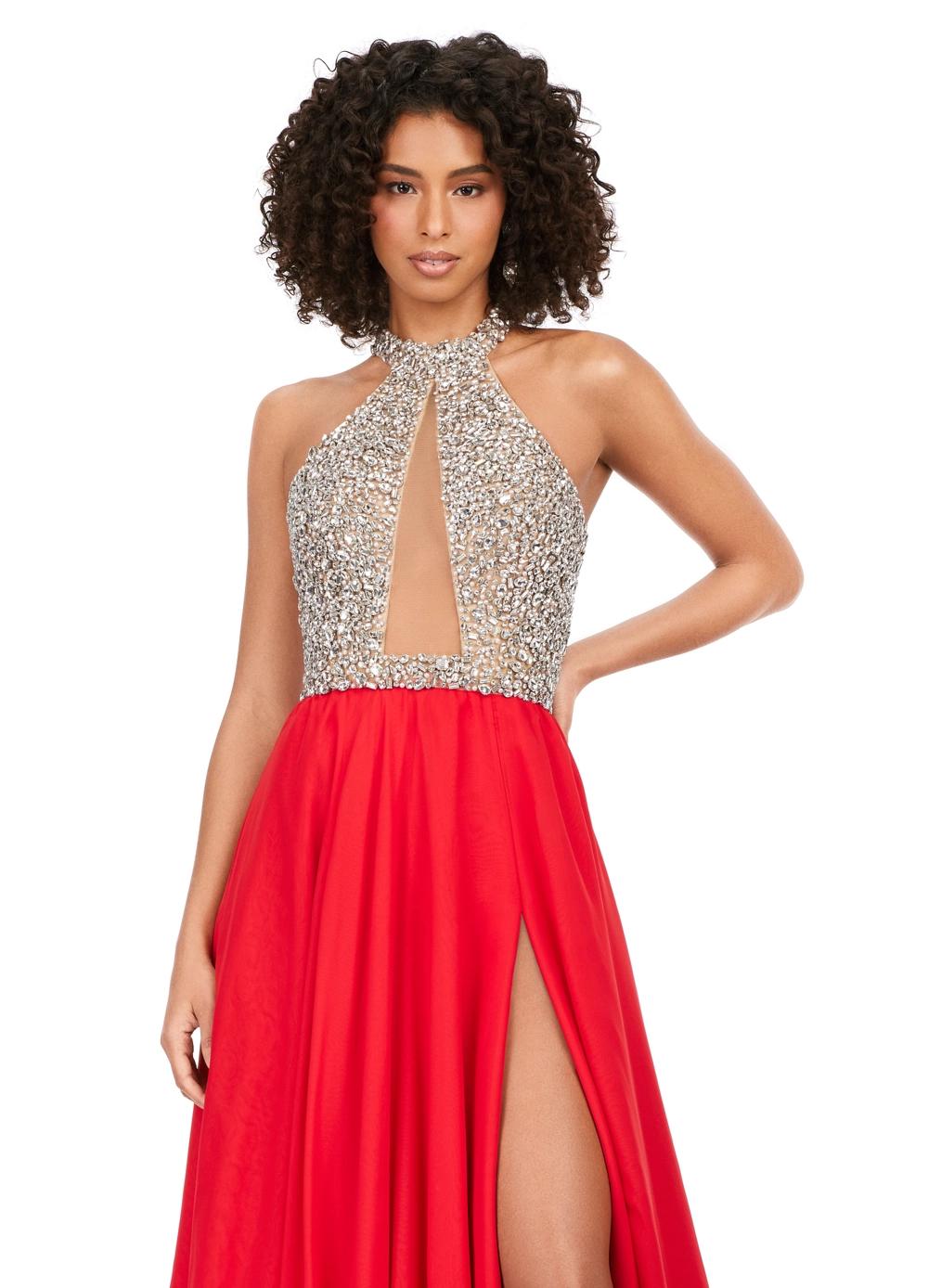 Red ASHLEYlauren 11248 – A stunning chiffon A-line gown featuring a beaded halter top with crystal details, an illusion cut-out, and a high left leg slit. Perfect for shining bright and making a statement at any special event.