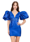 Royal ASHLEYlauren 4549 cocktail dress featuring a V-neckline, oversized puff sleeves, heat set stone-embellished waistband, fitted skirt, and center lace-up back for a bold and glamorous look.