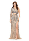 Silver ASHLEYlauren 11261 fully hand-beaded one shoulder gown featuring a shark bite cut out at the waist, left leg slit, and intricately placed bead pattern to accentuate curves, complete with scattered fringe along the shoulder and waistline for a bold and glamorous look.