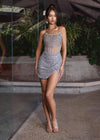 Silver ASHLEYlauren 4564 strapless cocktail dress featuring an illusion bustier with exposed boning and a wrap sequin skirt for a modern and sophisticated look.