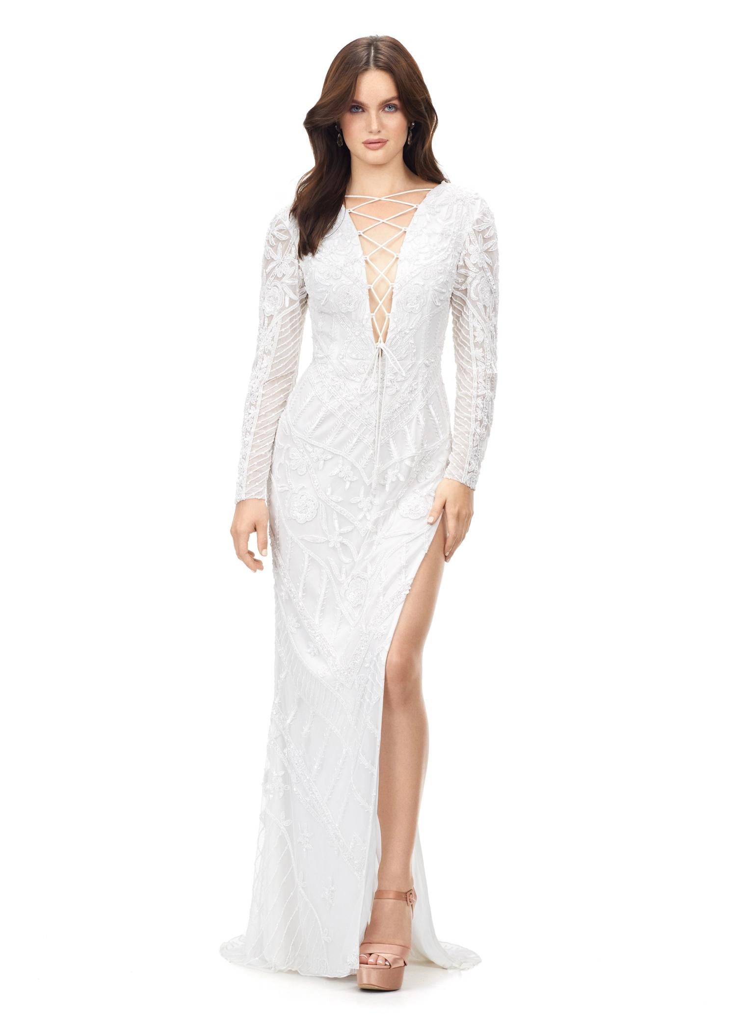 White ASHLEYlauren 11239 – A dramatic gown featuring intricate bead detailing, a lace-up bustier, long sleeves, and a left leg slit. Perfect for making a bold, glamorous statement at any special occasion.
