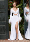 White ASHLEYlauren 11308 striking scuba gown featuring a deep V-neckline, criss-cross cut out bodice, crystal waistline, long sleeves adorned with heat-set stones and feather trim, a fitted skirt, and a left leg slit for a bold and glamorous statement look.
