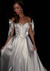 Video - Regal satin ball gown featuring a structured corset bustier, a flattering sweetheart neckline, and elegant off-the-shoulder bow straps. Finished with a voluminous skirt for a timeless princess look. Perfect for special occasions.