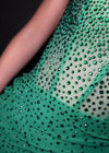 Video -  Emerald ASHLEYlauren 4690 stunning cocktail dress featuring an illusion neckline, corset bustier with press-on stones cascading down the skirt, and a wrap skirt with a side slit for an elegant and head-turning look.