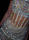 Video - Statement-making gown featuring intricate beadwork, exposed corset boning, and a high halter neckline adorned with draped crystal beading. Finished with a sweep train for an ultra-glamorous look. Perfect for high-fashion events.
