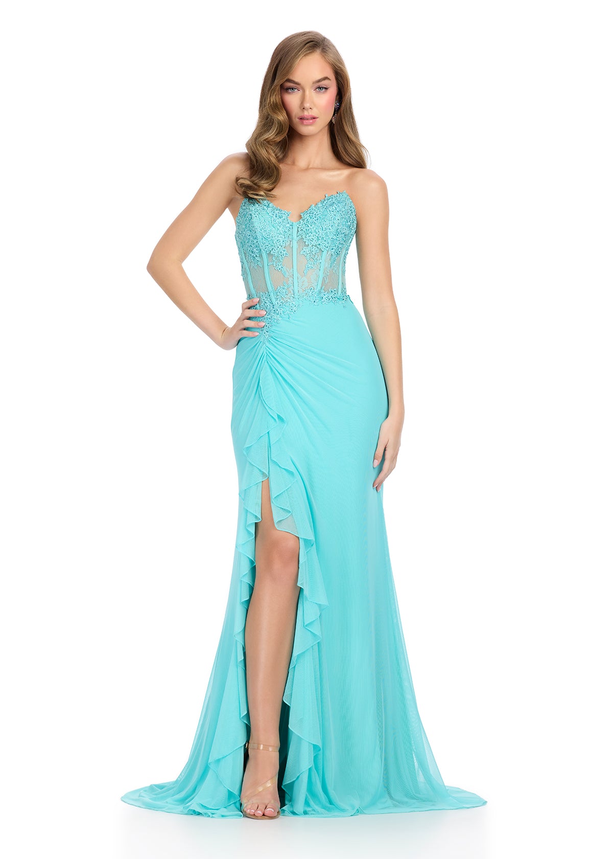 Statement-making gown featuring a structured corset bustier adorned with intricate embroidered appliqué, a ruffle-accented right leg slit, and a sweep train for a glamorous and elegant finish. Perfect for special occasions.
