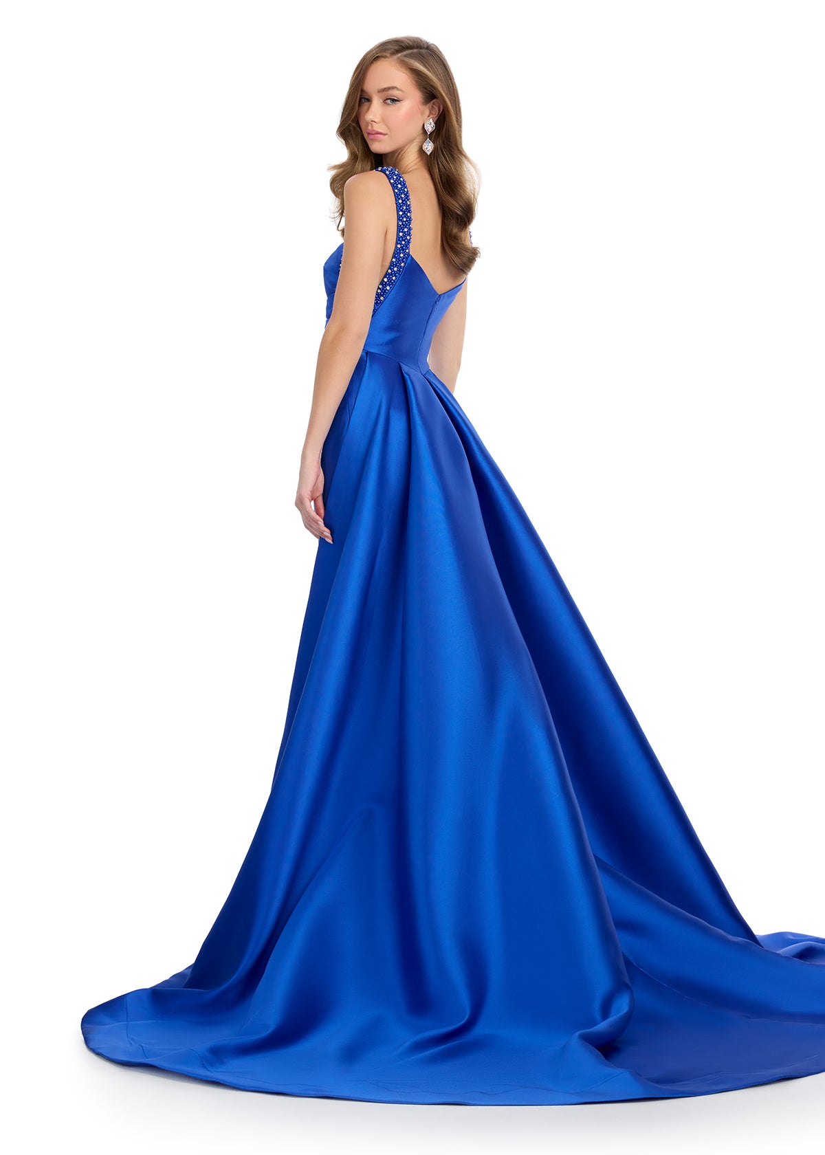 Back -  Regal mikado gown featuring fully beaded straps, a ruched bustier for a flattering fit, a sleek column skirt, and a sweeping overskirt for a dramatic, timeless look. Perfect for making a grand entrance.