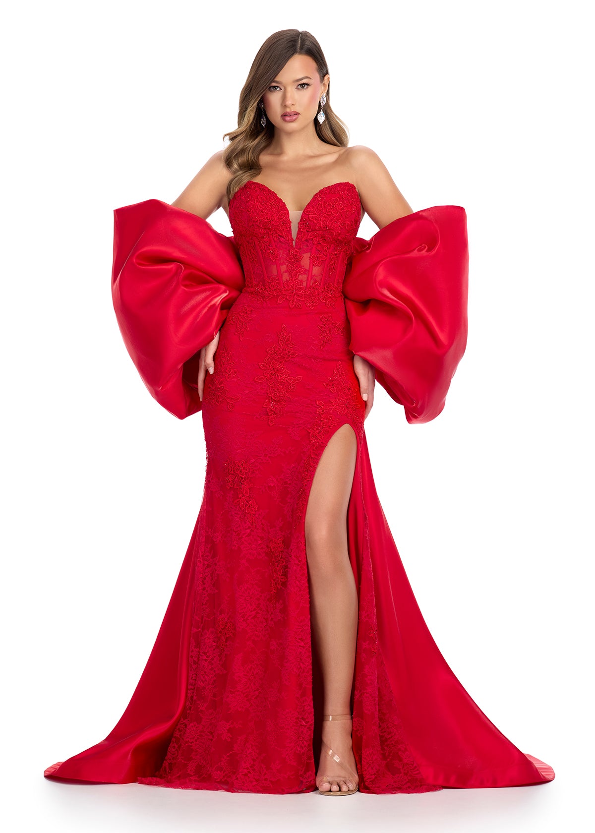 Statement-making off-shoulder cape featuring an oversized bow and flowing overskirt. The perfect accessory to elevate your prom or pageant look with elegance and drama.