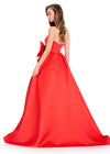 ASHLEYlauren 12396 Gown | Strapless Red gown featuring a fitted bodice, statement bow at the waist, and a full skirt with an elegant extended train