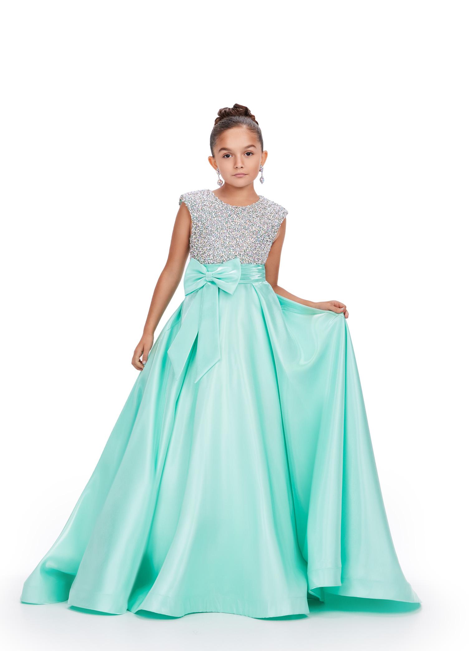 Aqua ASHLEYlauren 8247 adorable kids ball gown featuring a fully embellished cap sleeve bodice, ruched waistline, and a full satin skirt accented with a bow for a charming and elegant look.
