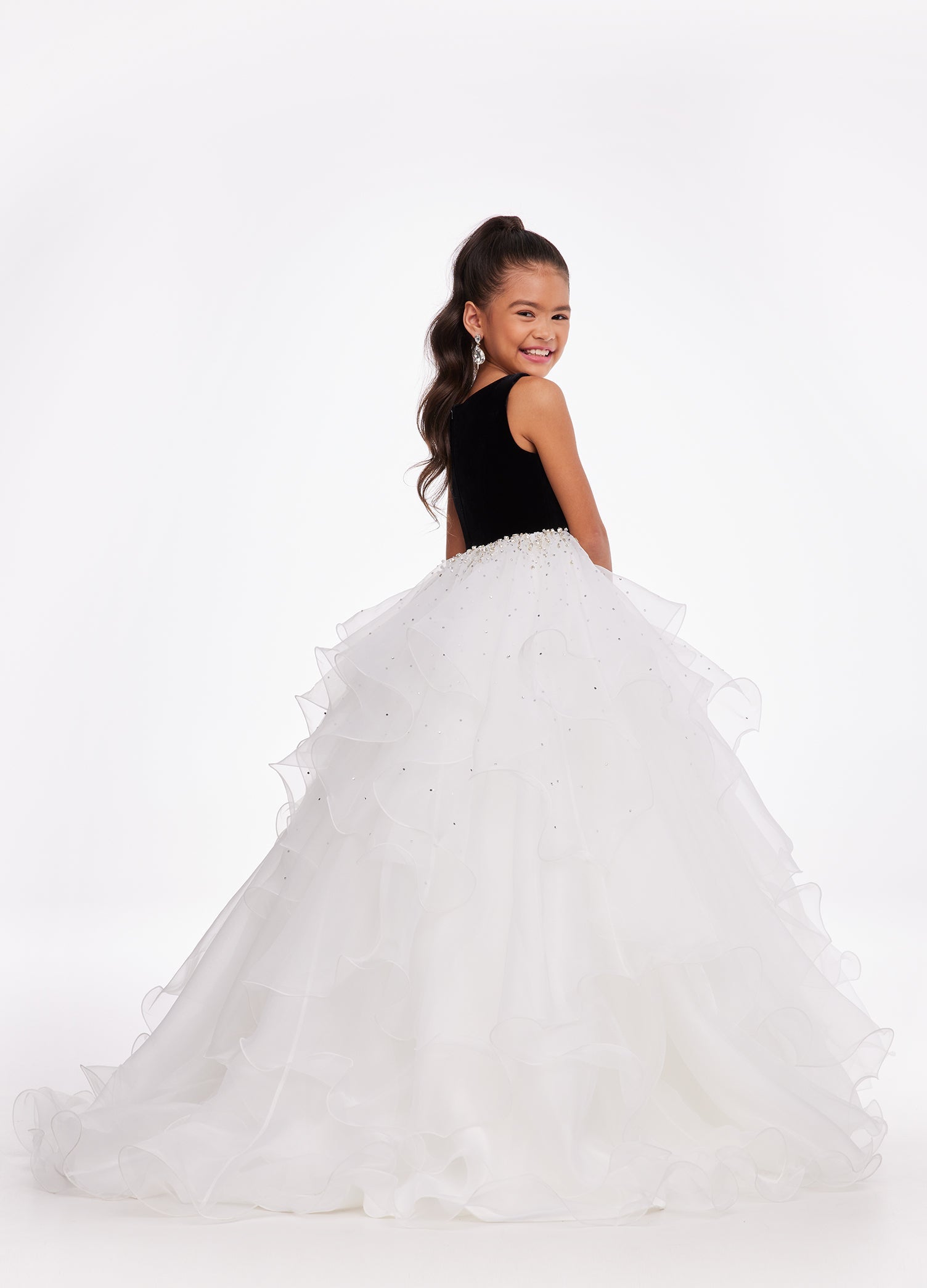 Back. Black/Ivory ASHLEYlauren Kids 8120 elegant ball gown featuring a crew neckline, velvet bustier, beaded waistline, and cascading press-on stone details over a handkerchief organza skirt for a sophisticated and graceful look.