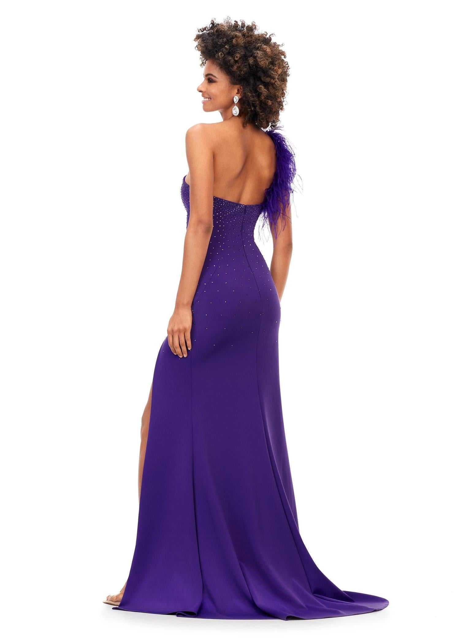 ASHLEYlauren 11290 | Orchid elegant scuba gown showcases a one shoulder design with feather embellishment and heat set stones flowing down the skirt. A thigh high slit creates a sleek and confident finish.