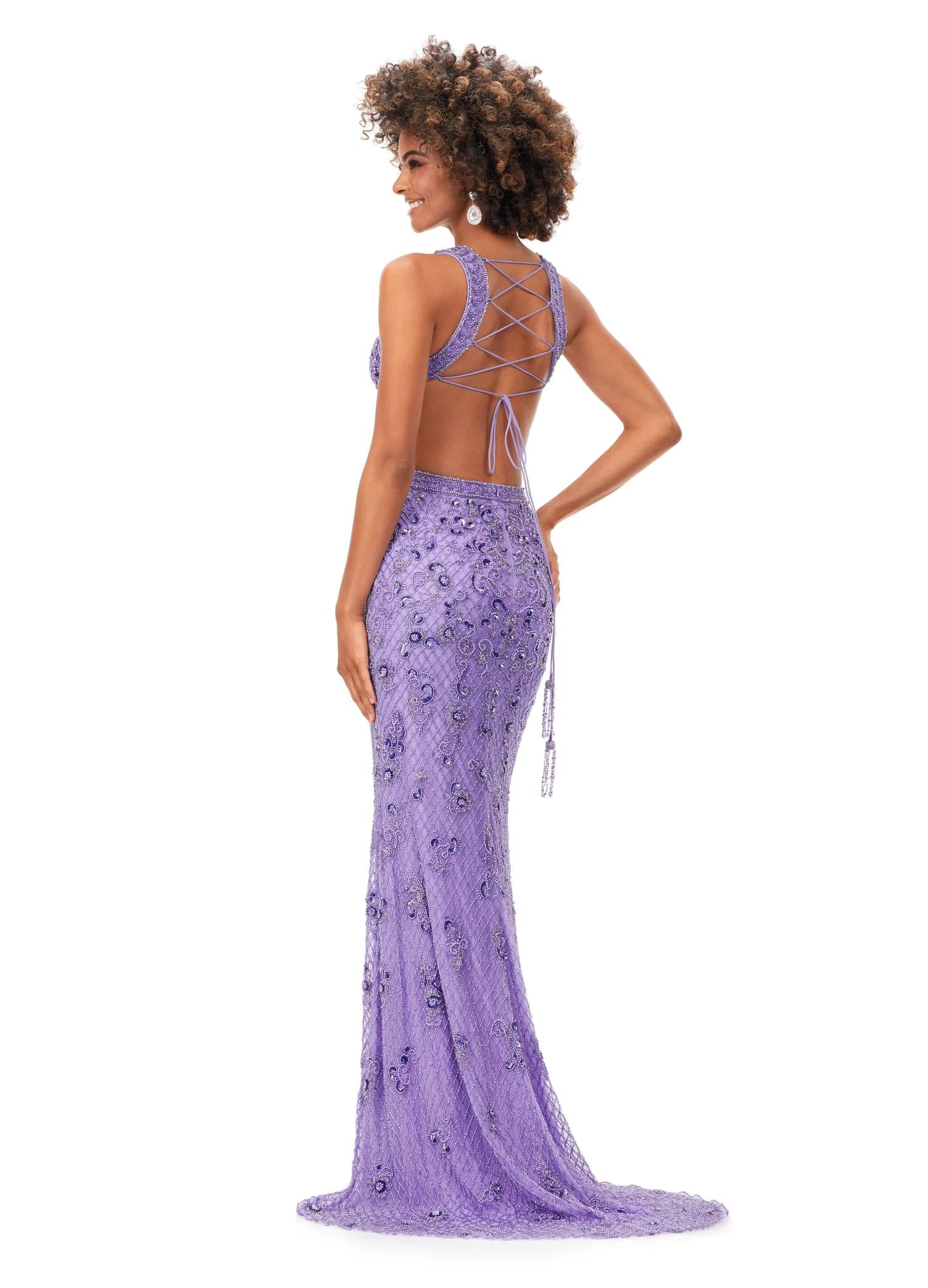 Back. Lilac ASHLEYlauren 11366 stunning hand-beaded gown featuring a deep V-neckline, intricate bead pattern, side cut outs, a lace-up open back, and a sweep train for a bold and glamorous statement look.