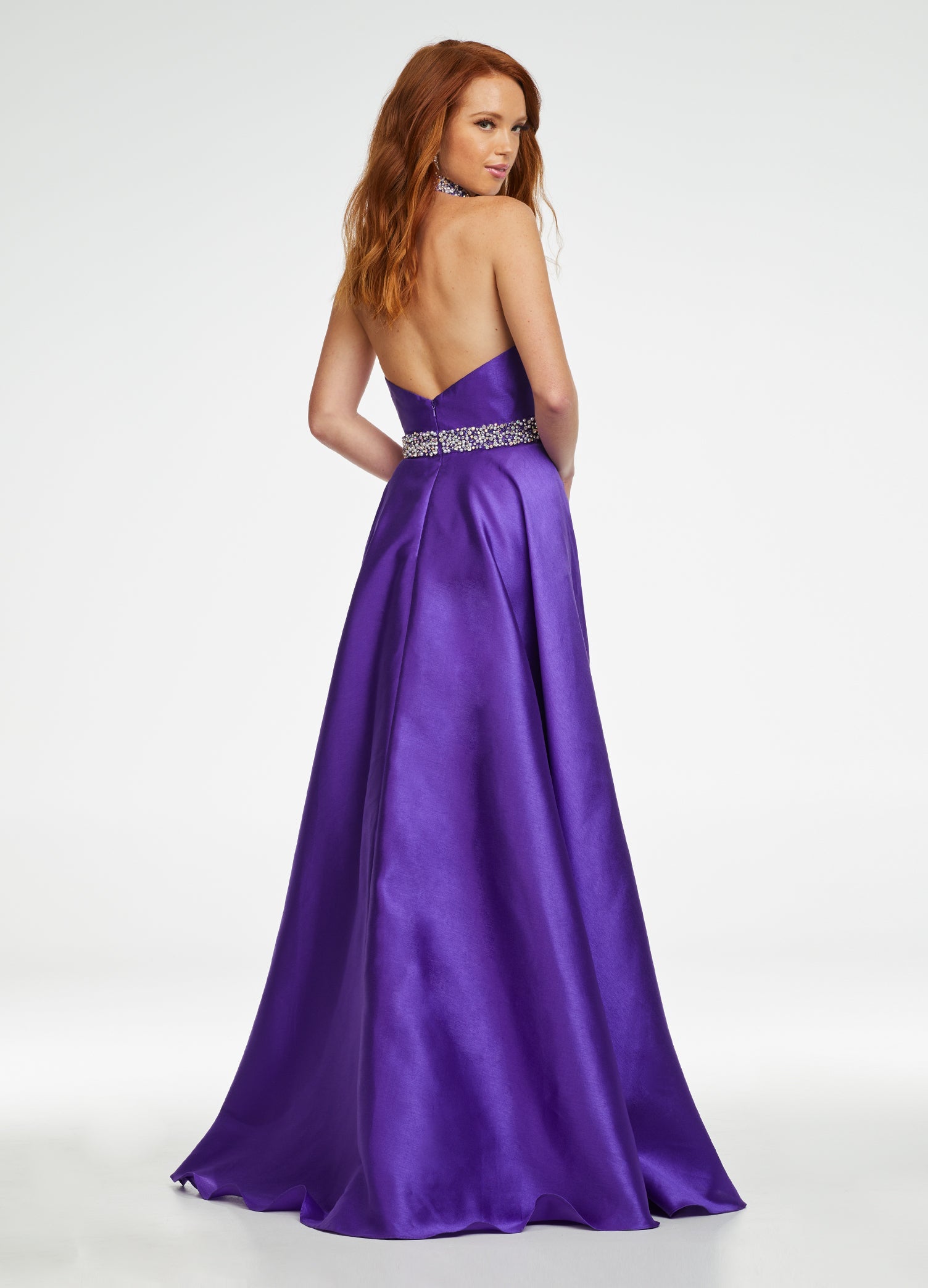 Back. Purple ASHLEYlauren 11148 High Neck Mikado Column Gown with Open Back, Beaded Neckline and Belt, and Attached Overskirt
