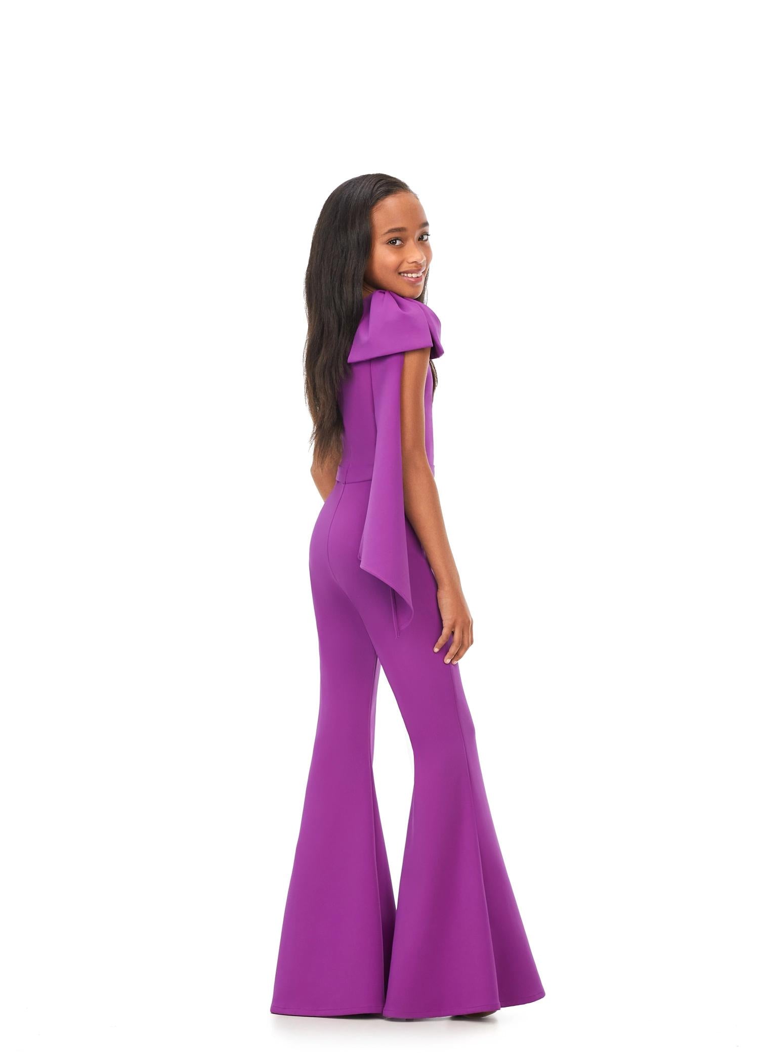 Back. Purple ASHLEYlauren Kids 8155 stylish one shoulder scuba jumpsuit featuring a statement bow with long tails on the shoulder and flare bell-bottom pants for a fun and fabulous look.