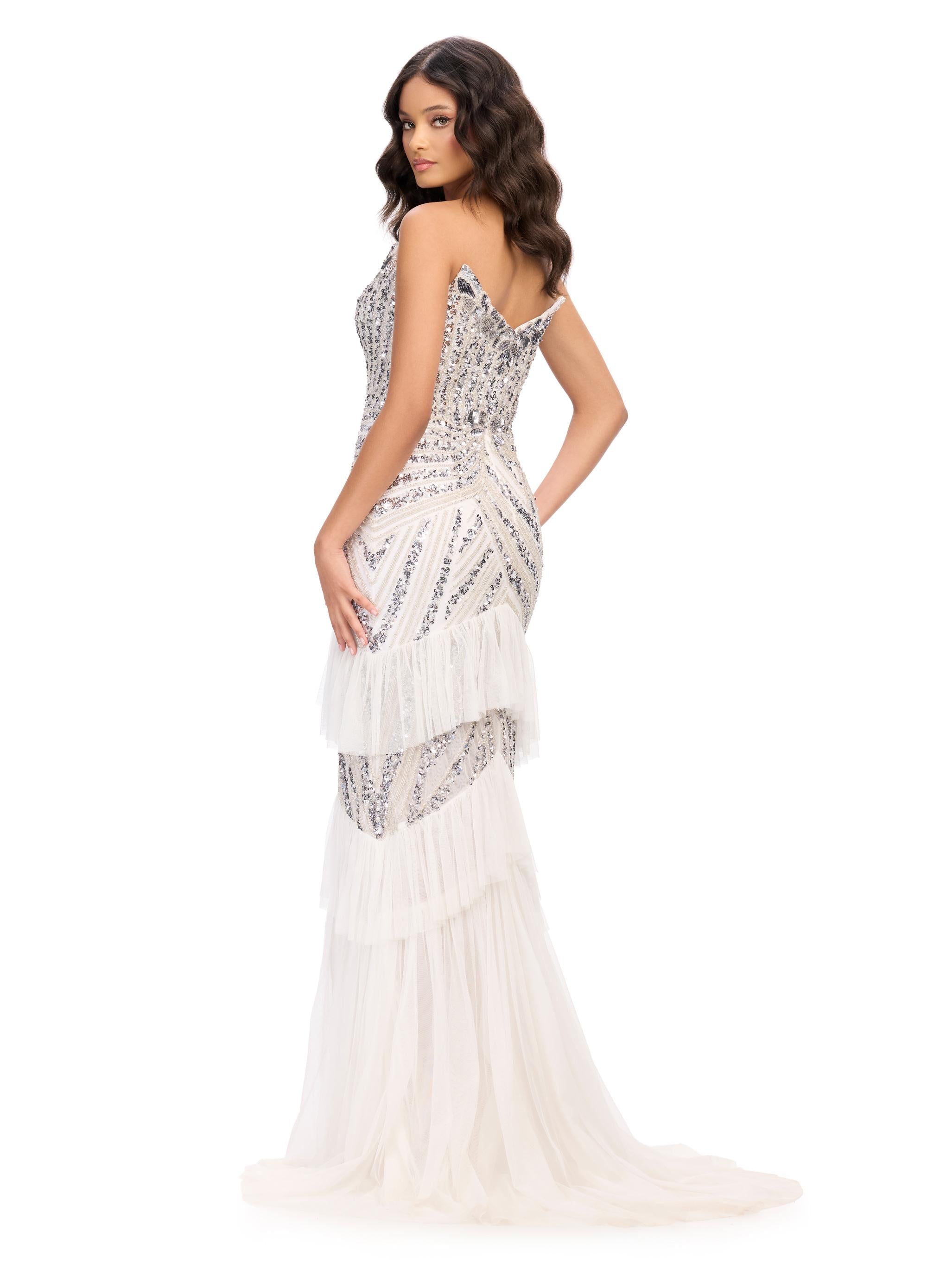 Back. Silver/Ivory ASHLEYlauren 11438 glamorous gown featuring a sweetheart illusion V-neckline, ornate bead pattern, striking V-back, tiered ruffle skirt, and a center slit with tulle details for an elegant and dramatic look.