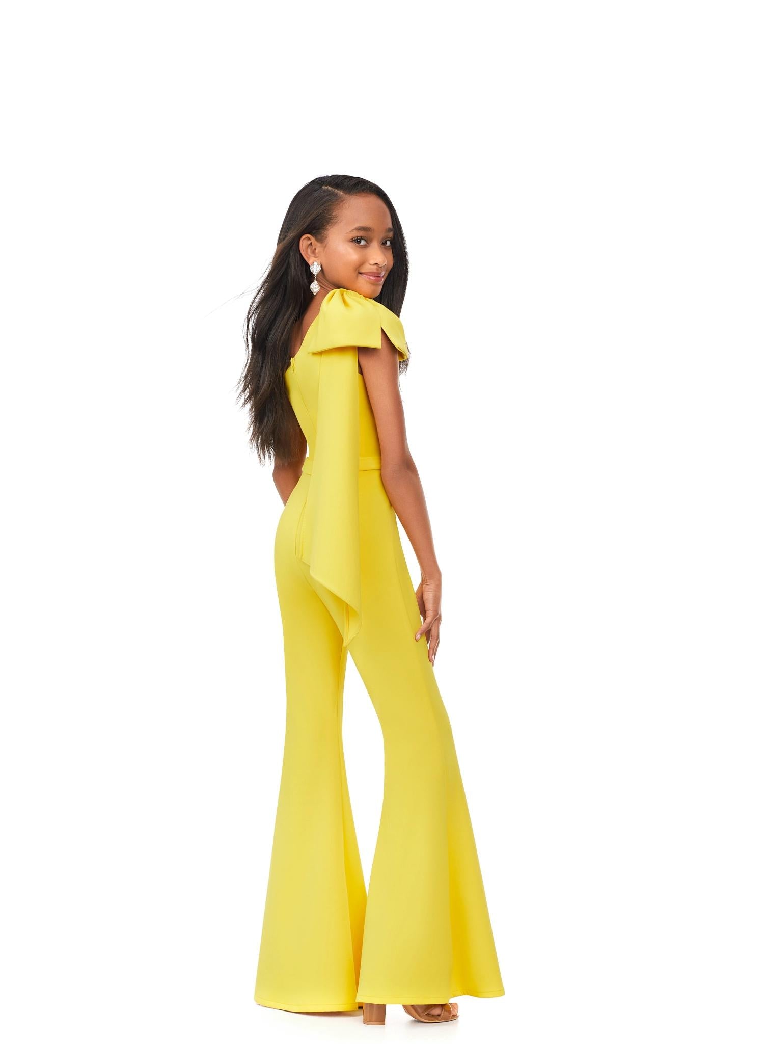 Back. Yellow ASHLEYlauren Kids 8155 stylish one shoulder scuba jumpsuit featuring a statement bow with long tails on the shoulder and flare bell-bottom pants for a fun and fabulous look.