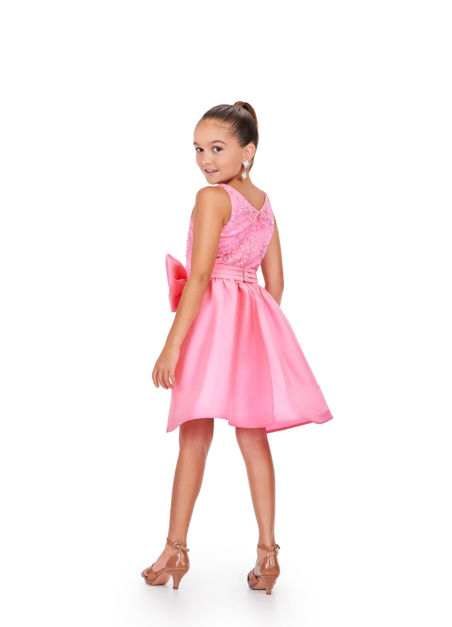 Back - Pink ASHLEYlauren 8266 kids cocktail dress featuring a crew neckline, intricately beaded bow pattern, V-back, and a removable taffeta overskirt with an oversized bow for a charming and elegant look.