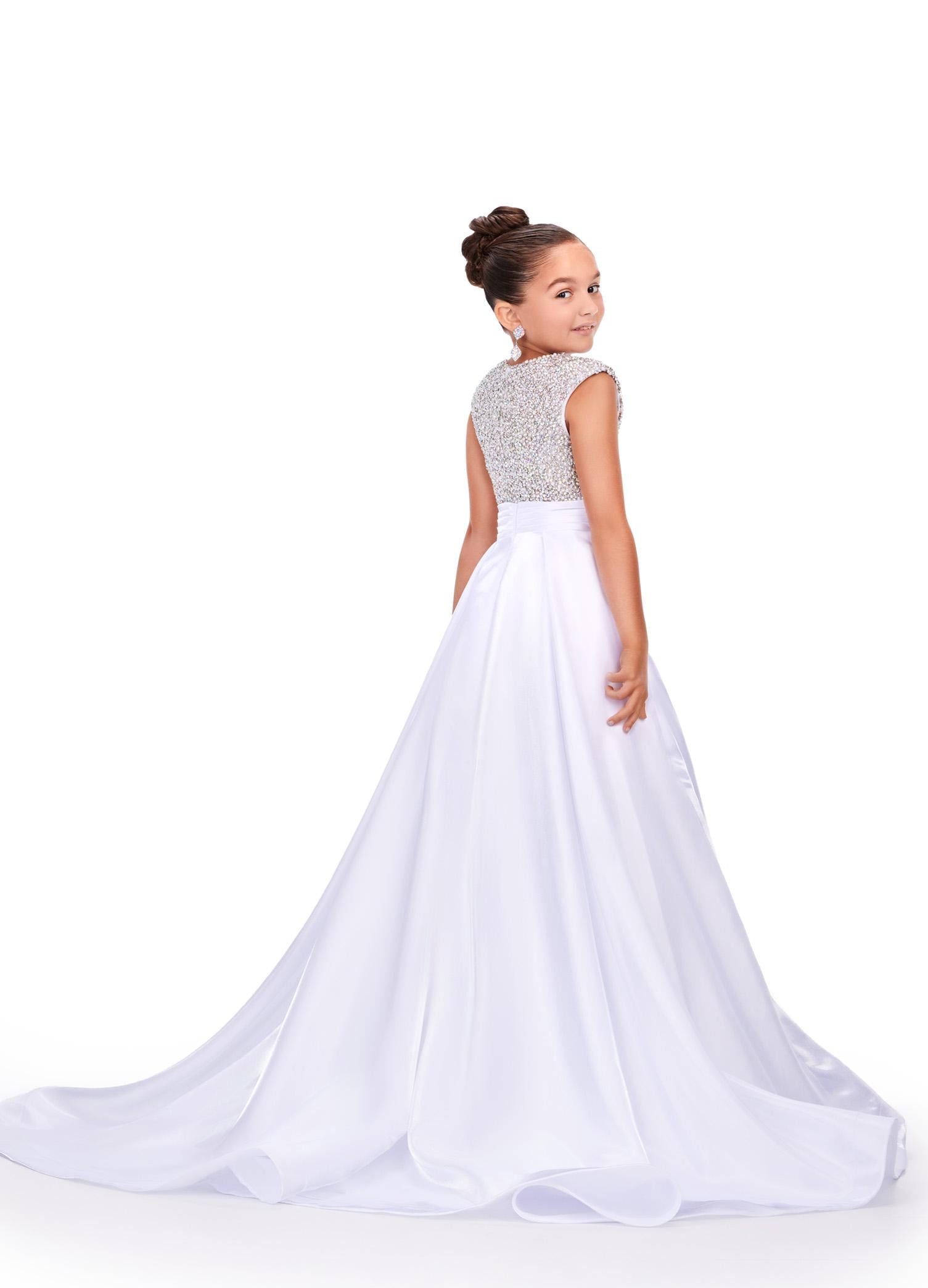 Back - White ASHLEYlauren 8247 adorable kids ball gown featuring a fully embellished cap sleeve bodice, ruched waistline, and a full satin skirt accented with a bow for a charming and elegant look.