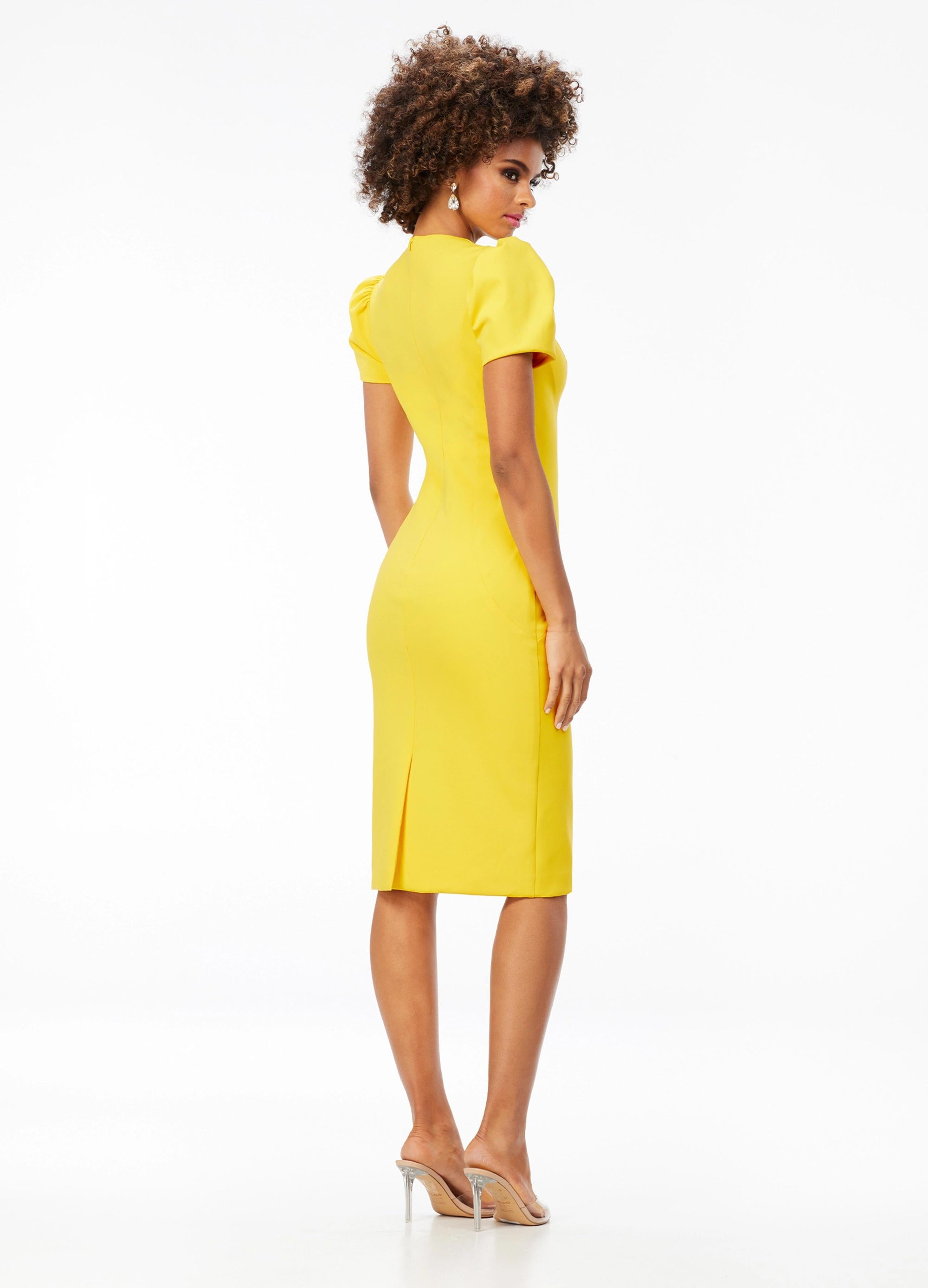 Back - Yellow ASHLEYlauren 4534 scuba cocktail dress featuring a modified square neckline, dramatic puff sleeves, fitted tea-length skirt, and full zipper back for a sophisticated and stylish look.