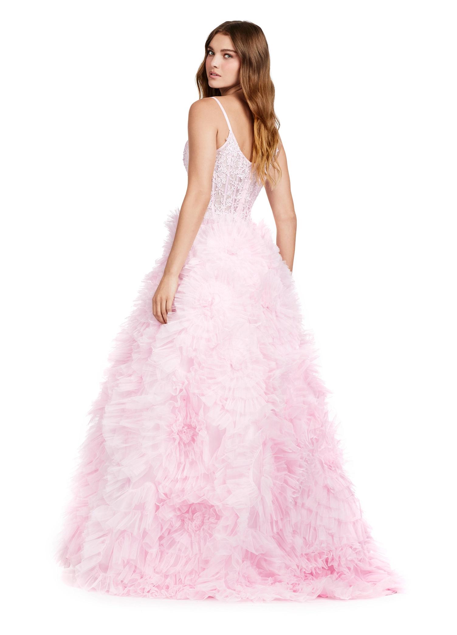 Back view. ASHLEYlauren 11446 blush pink tulle gown with ruffled A-line skirt, corset bustier, deep illusion V-neckline, and leg slit