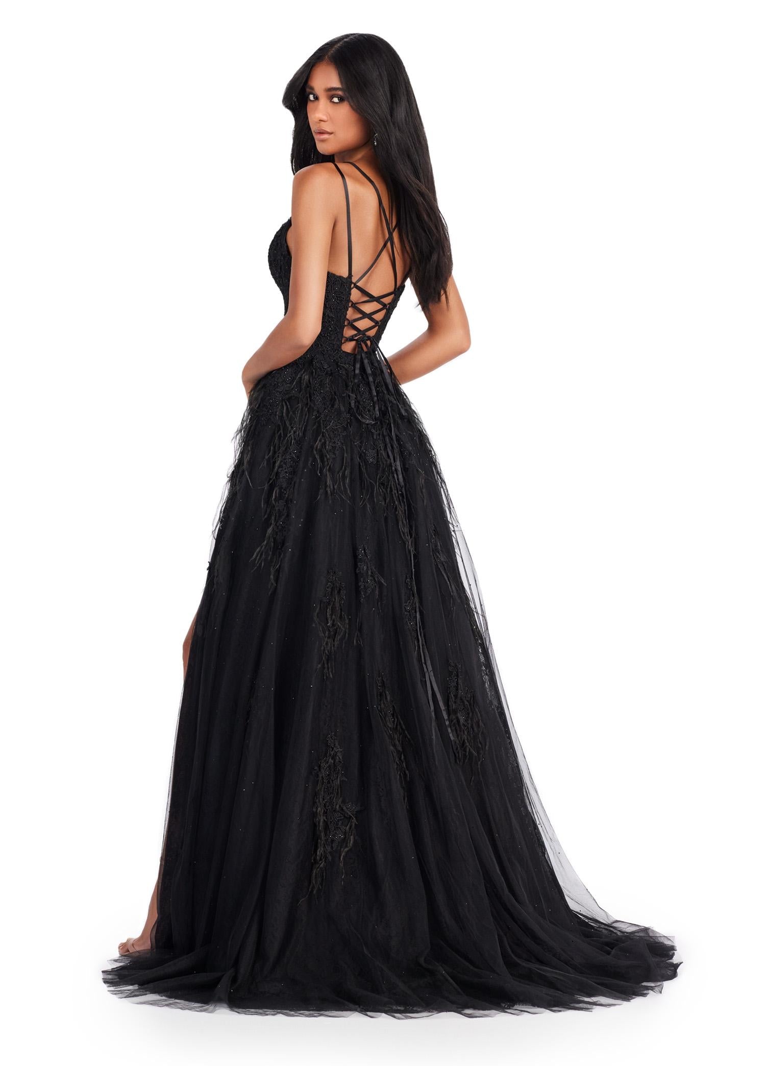 Back view. ASHLEYlauren 11480 back A-line gown with feather and jewel embellishments, corset bodice, lace up back, and left leg slit
