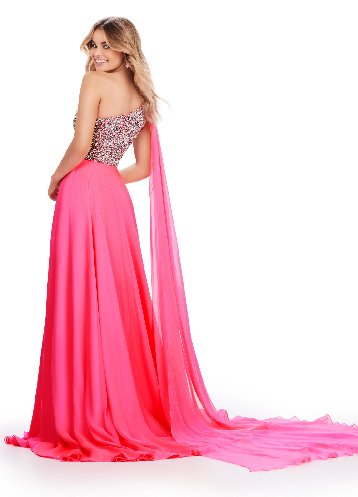 Back view. ASHLEYlauren 11482 hot pink one shoulder gown with fully beaded bodice, chiffon cape, A-line skirt, and leg slit