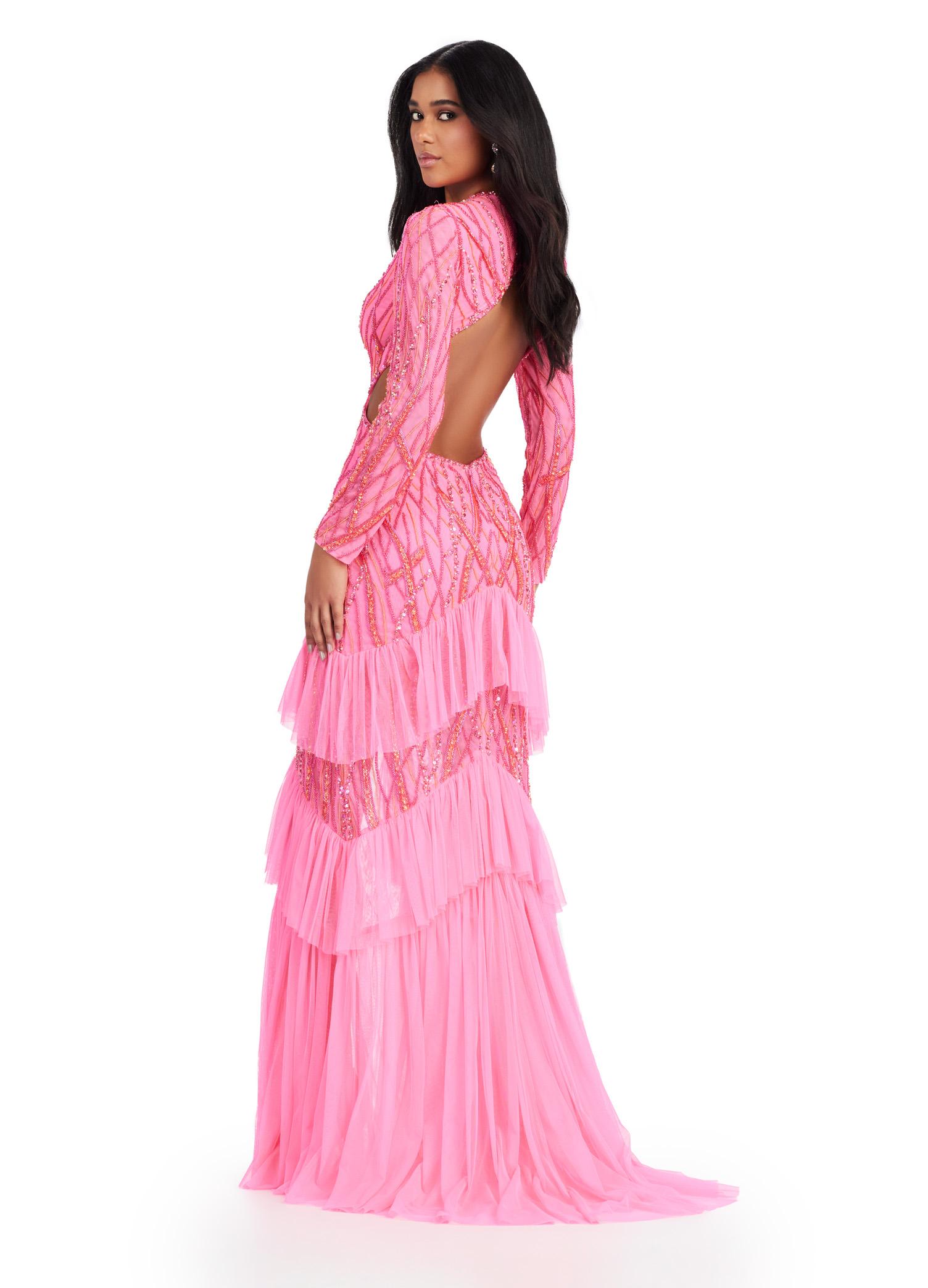 Back view. Pink ASHLEYlauren 11436 stunning fully beaded gown featuring a V-neckline, open back, long sleeves, and a tiered ruffle skirt with a center slit for a show-stopping entrance.