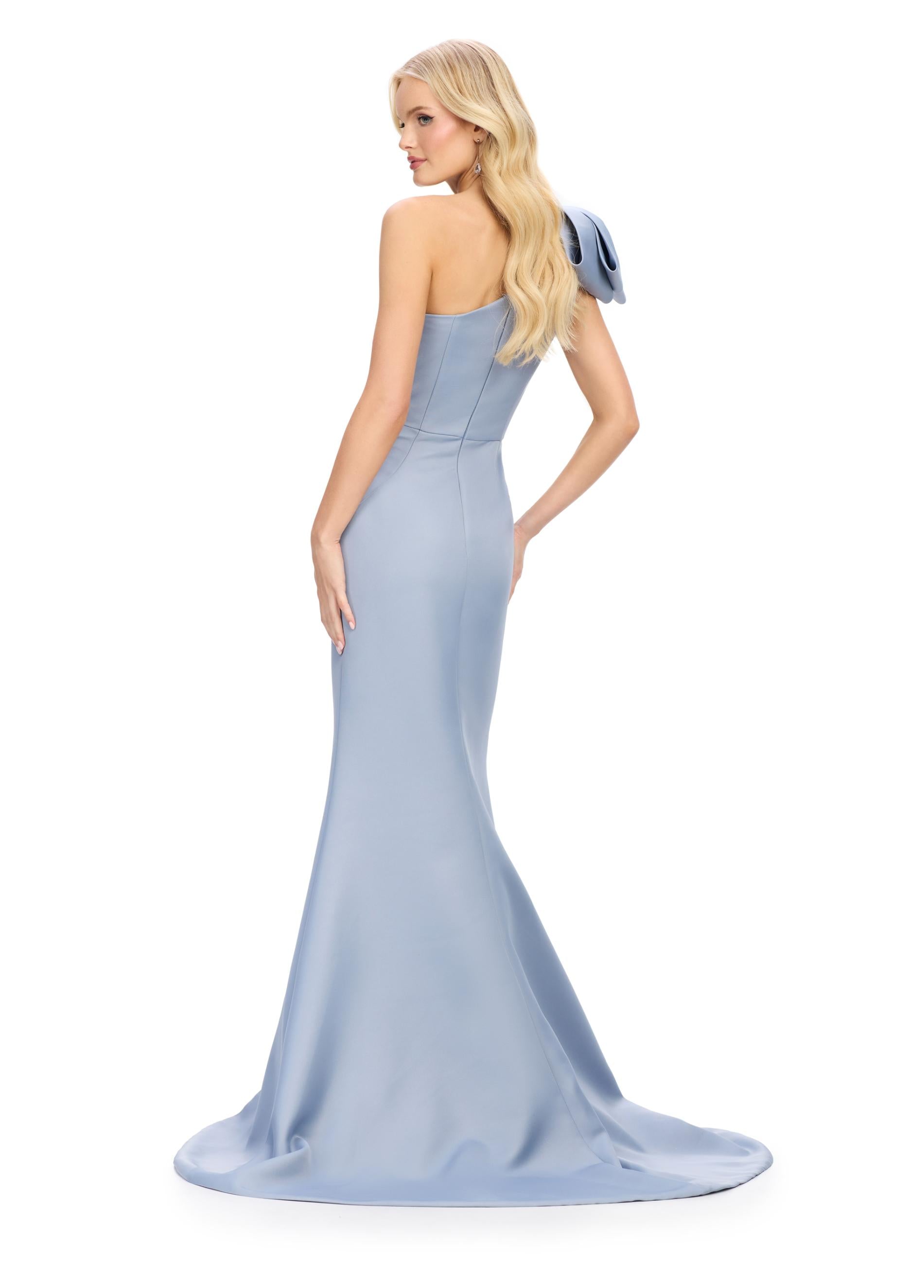Back view. Vintage Blue ASHLEYlauren 11759 elegant satin gown featuring a one shoulder neckline, dramatic oversized bow detail, and a left leg slit for a timeless silhouette.