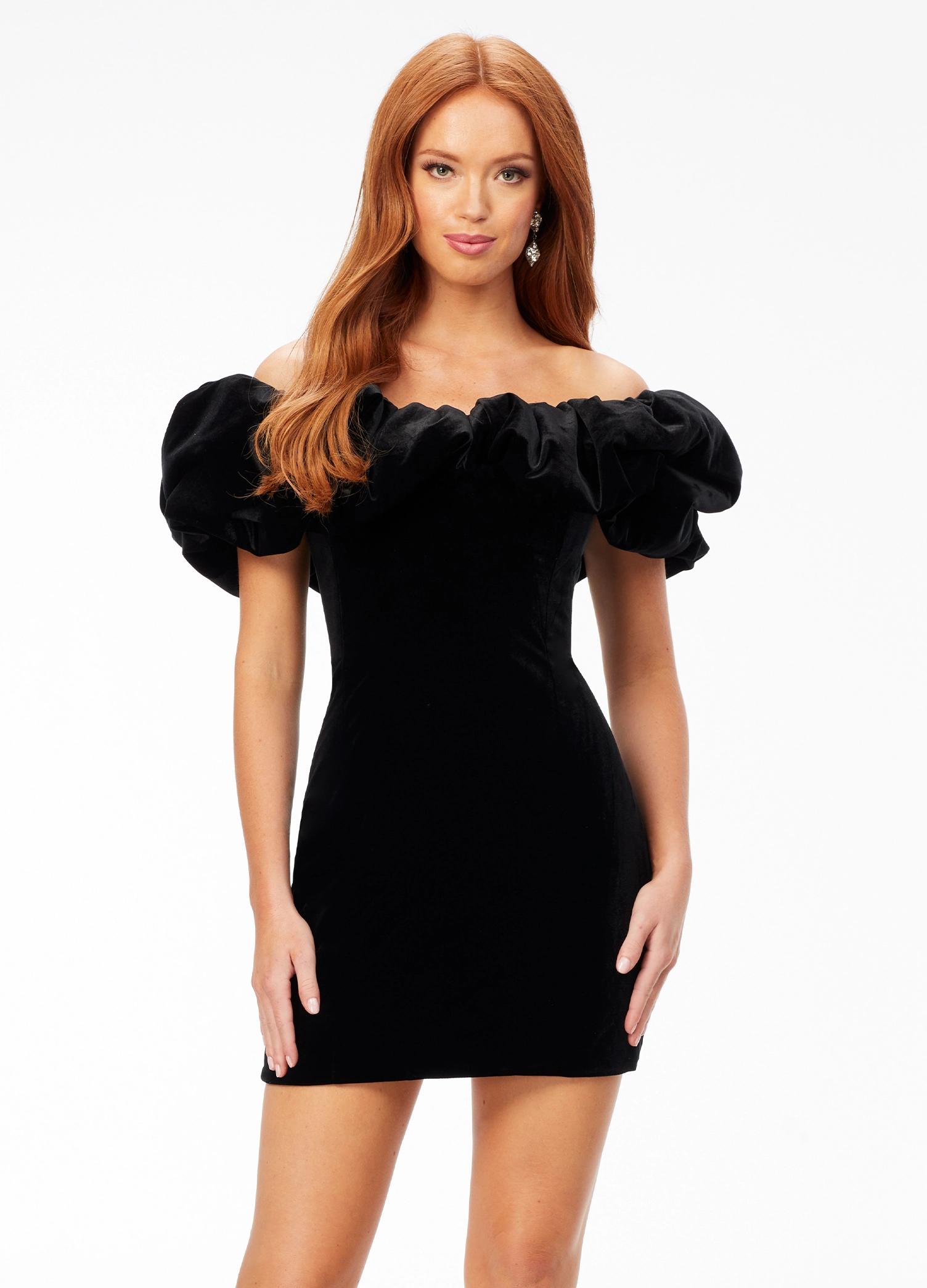 Black ASHLEYlauren 4528 off shoulder stretch velvet cocktail dress featuring an oversized ruffle detail and contoured seaming throughout the fitted skirt for a chic, curve-enhancing look.