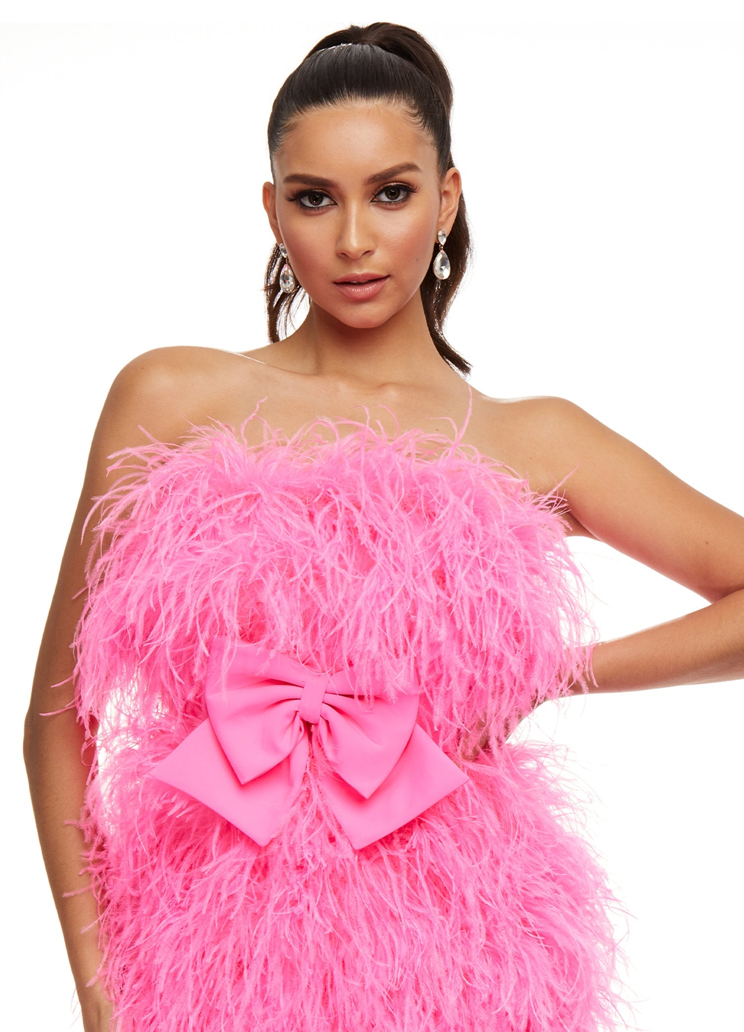 Close up - Pink ASHLEYlauren 4467 strapless cocktail dress featuring a fully feathered design and an oversized bow detail at the waist for a flirty and standout look.