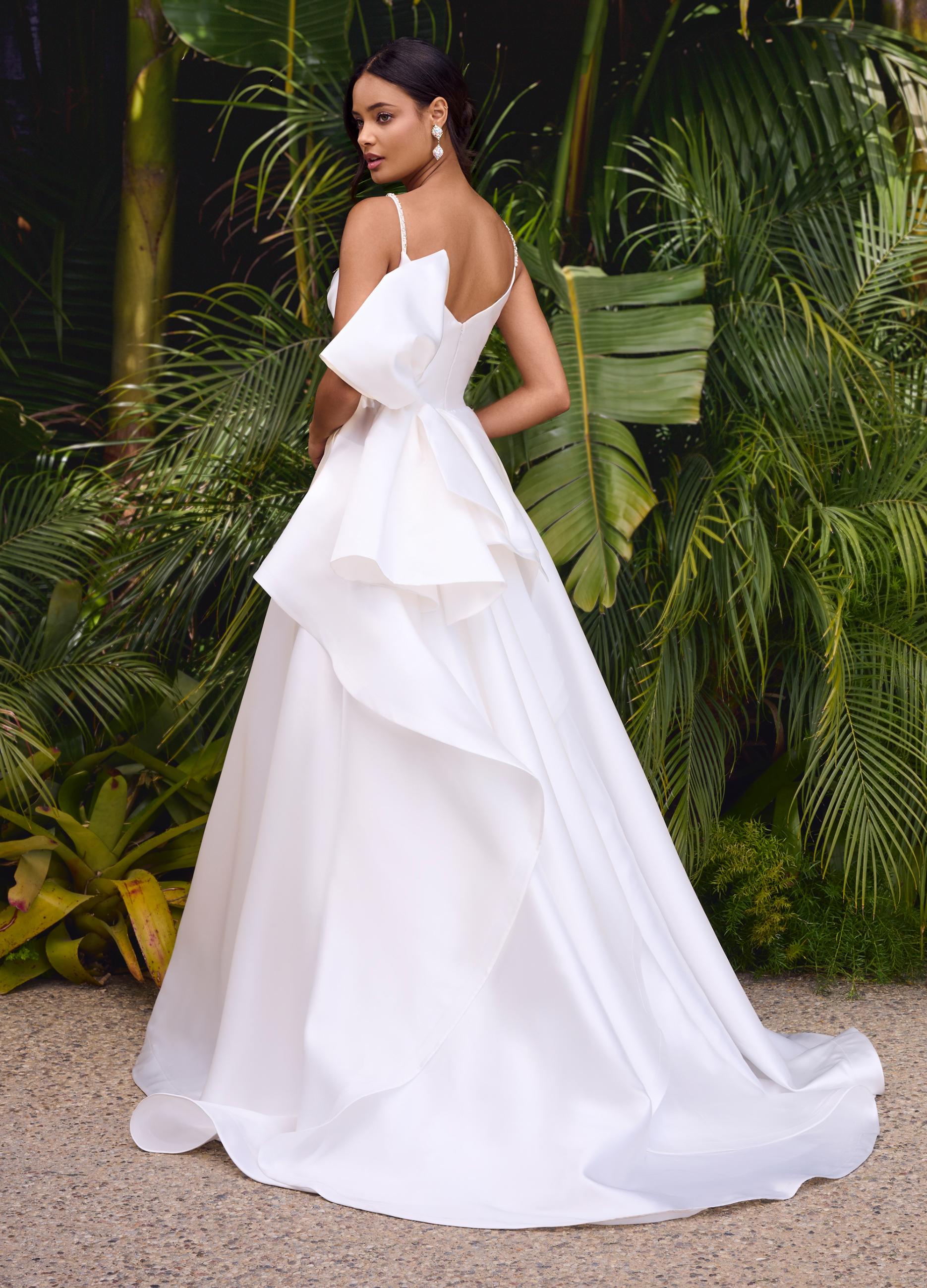Editorial\Back. White ASHLEYlauren 11769 stunning satin gown featuring a sweetheart neckline adorned with crystal details, ruched wrap bodice, dramatic oversized bow, and an A-line ball gown skirt for a glamorous and elegant look.
