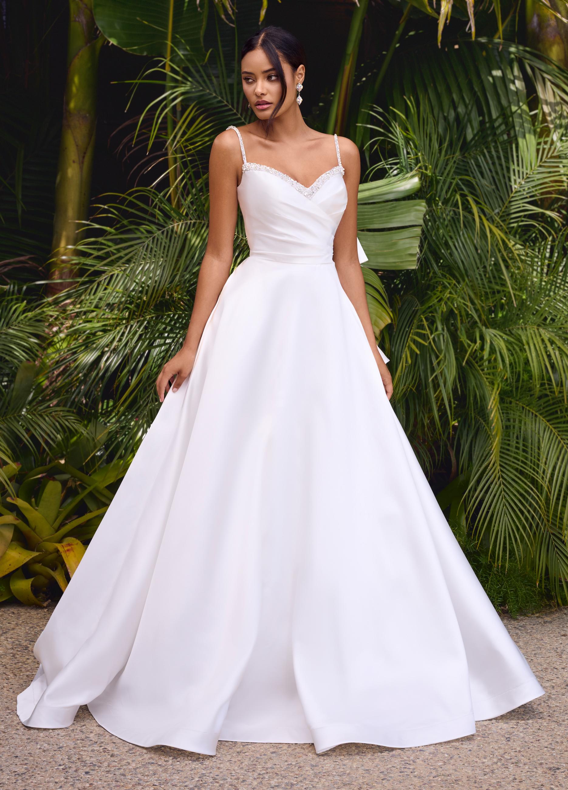 Editorial\Front. White ASHLEYlauren 11769 stunning satin gown featuring a sweetheart neckline adorned with crystal details, ruched wrap bodice, dramatic oversized bow, and an A-line ball gown skirt for a glamorous and elegant look.