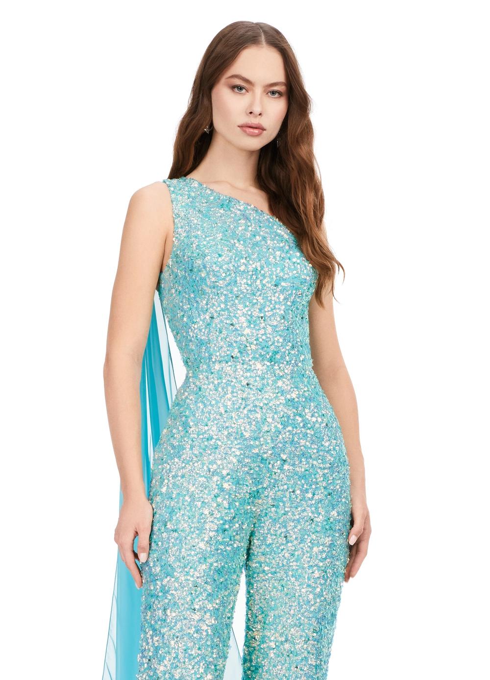 Front. Ab/Turquoise ASHLEYlauren 11384 eye-catching sequin jumpsuit featuring a one shoulder neckline, removable cape, open back with sequin straps, for a bold and glamorous statement look.