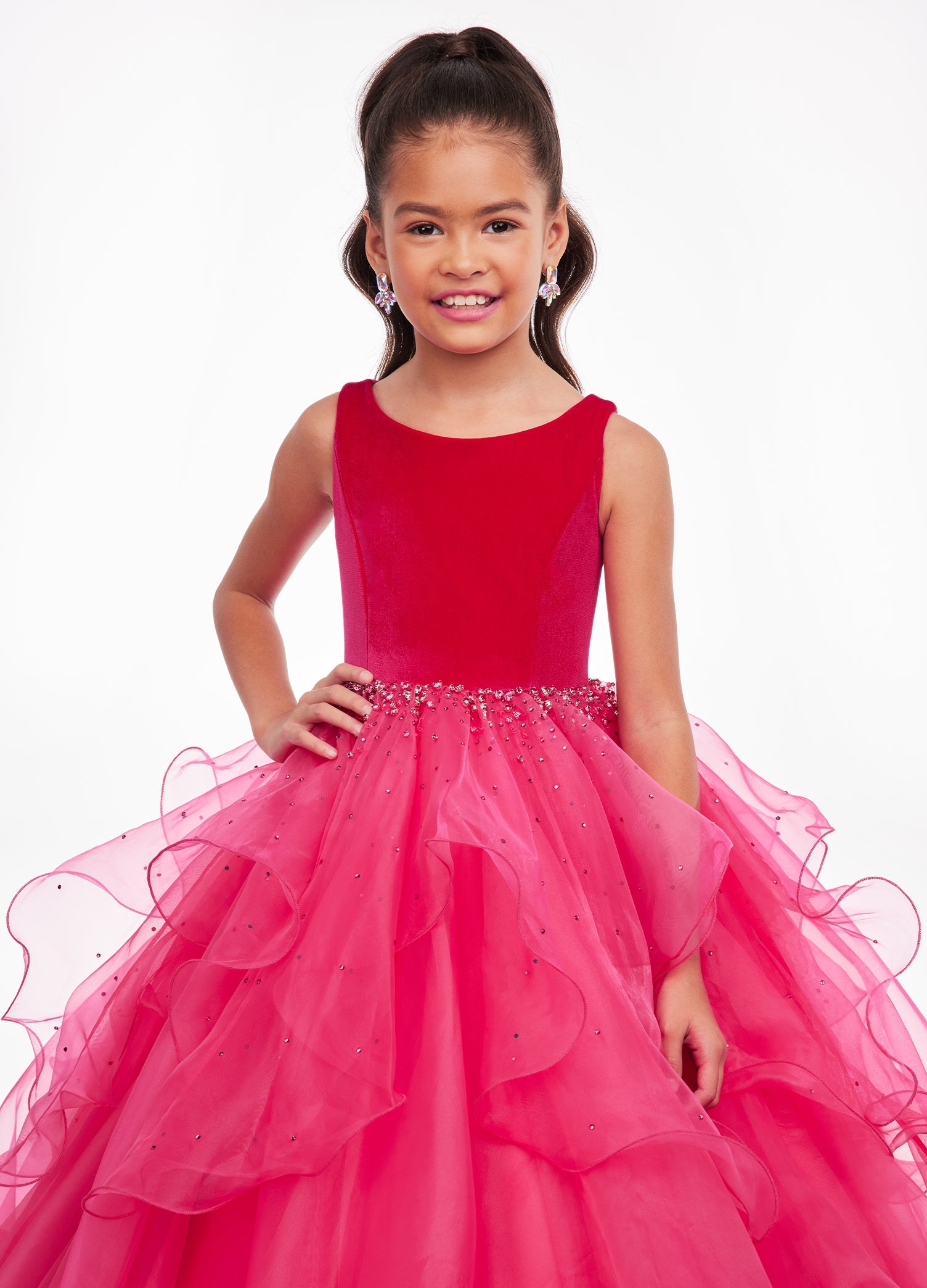 Front. Pink ASHLEYlauren Kids 8120 elegant ball gown featuring a crew neckline, velvet bustier, beaded waistline, and cascading press-on stone details over a handkerchief organza skirt for a sophisticated and graceful look.