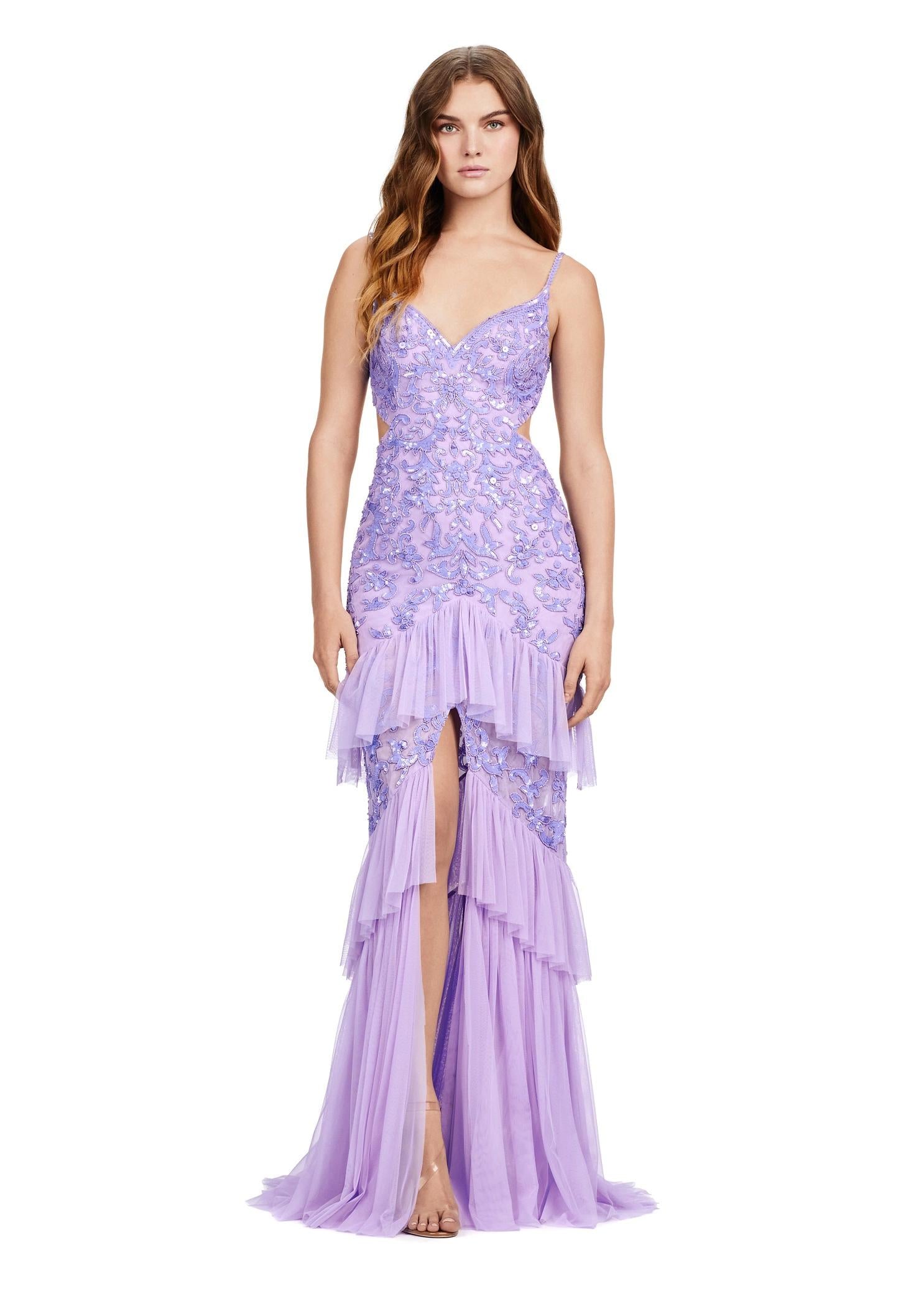 Front view. ASHLEYlauren 11436 Lilac fully beaded gown with V-neckline, long sleeves, open back, centre slit, and tiered ruffle skirt