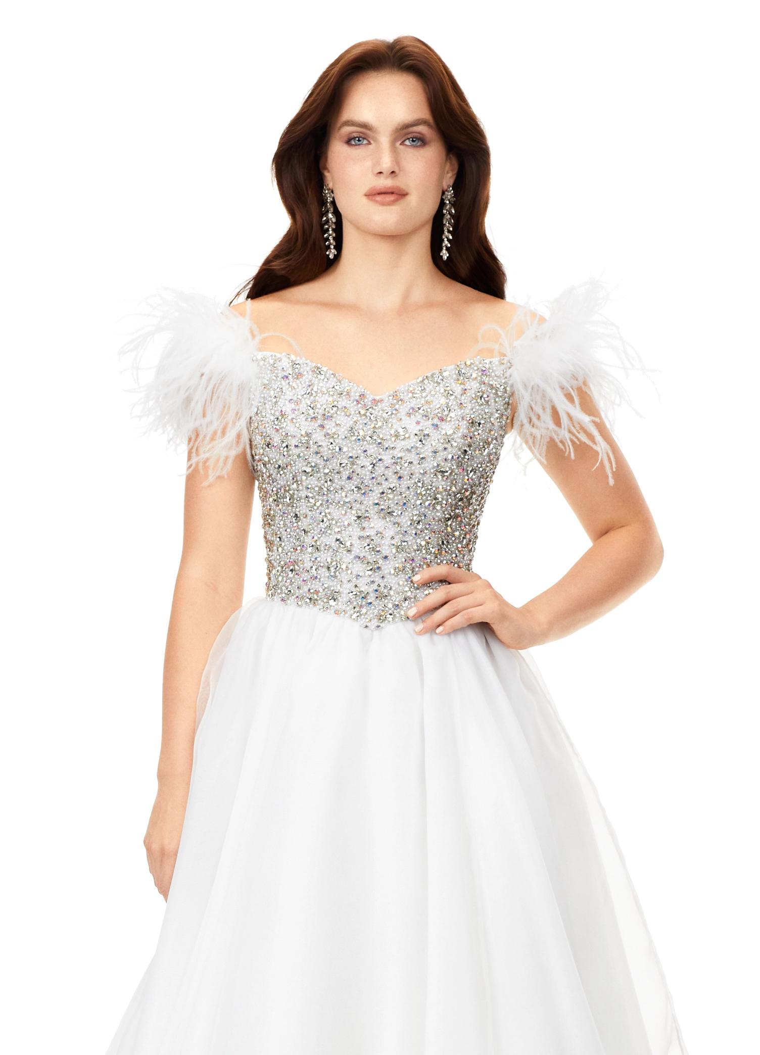 Ivory ASHLEYlauren 11314 off shoulder gown featuring feather straps, a crystal-encrusted bustier, and a flowing organza A-line skirt with wire hem.