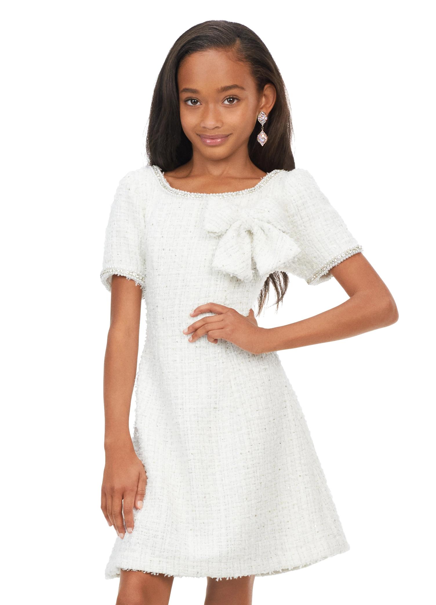 Ivory ASHLEYlauren Kids 8172 multi tweed cocktail dress featuring a crew neckline, short sleeves trimmed with pearls and crystals, and a beautiful bow detail on the bodice for a chic and elegant look.