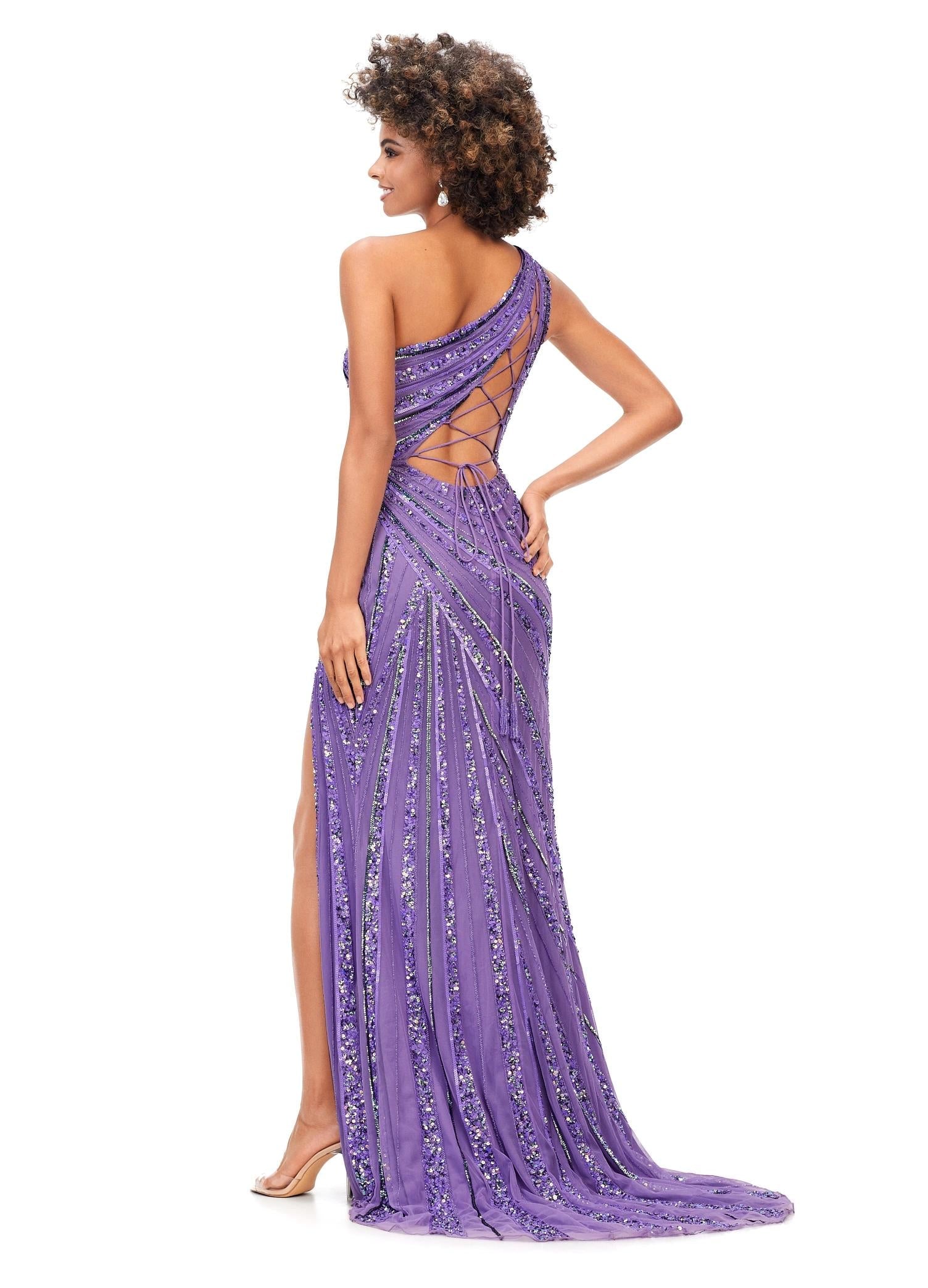 Back - Orchid ASHLEYlauren 11244 – A stunning one-shoulder gown featuring intricate beadwork that accentuates your curves, a left leg slit, and a signature asymmetrical lace-up back. Perfect for making a show-stopping statement at any event.