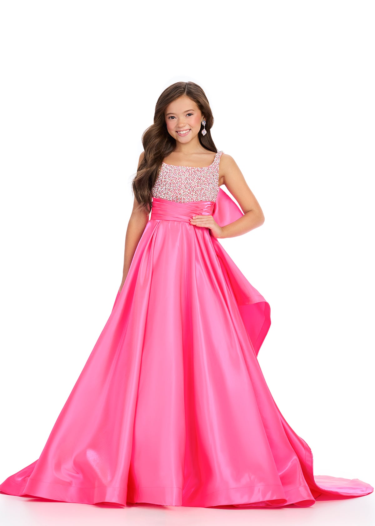Pink ASHLEYlauren 8278 charming satin kids ball gown featuring a fully beaded bustier, an oversized bow detail, and a sweep train for a glamorous and statement-making look.