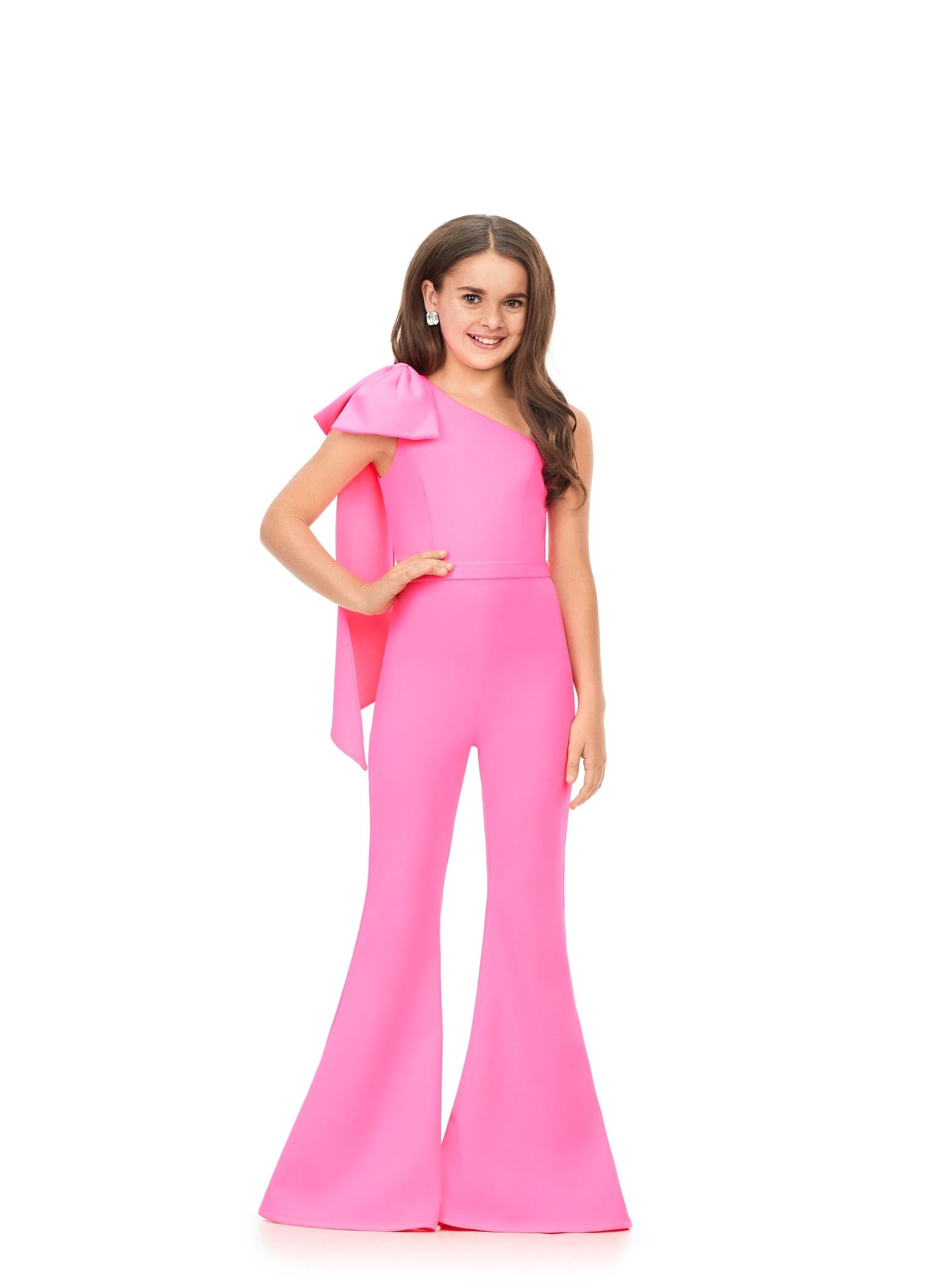 Pink ASHLEYlauren Kids 8155 stylish one shoulder scuba jumpsuit featuring a statement bow with long tails on the shoulder and flare bell-bottom pants for a fun and fabulous look.