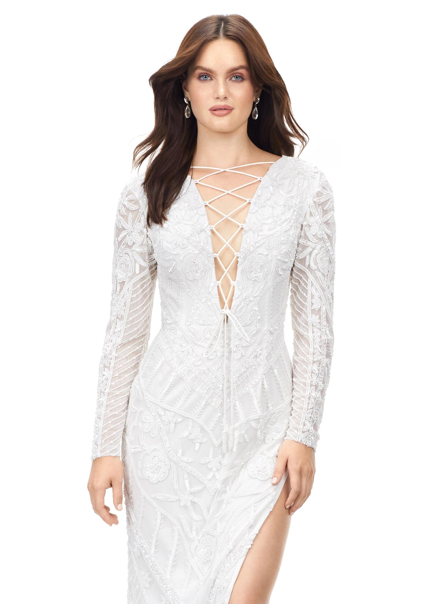 White ASHLEYlauren 11239 – A dramatic gown featuring intricate bead detailing, a lace-up bustier, long sleeves, and a left leg slit. Perfect for making a bold, glamorous statement at any special occasion.