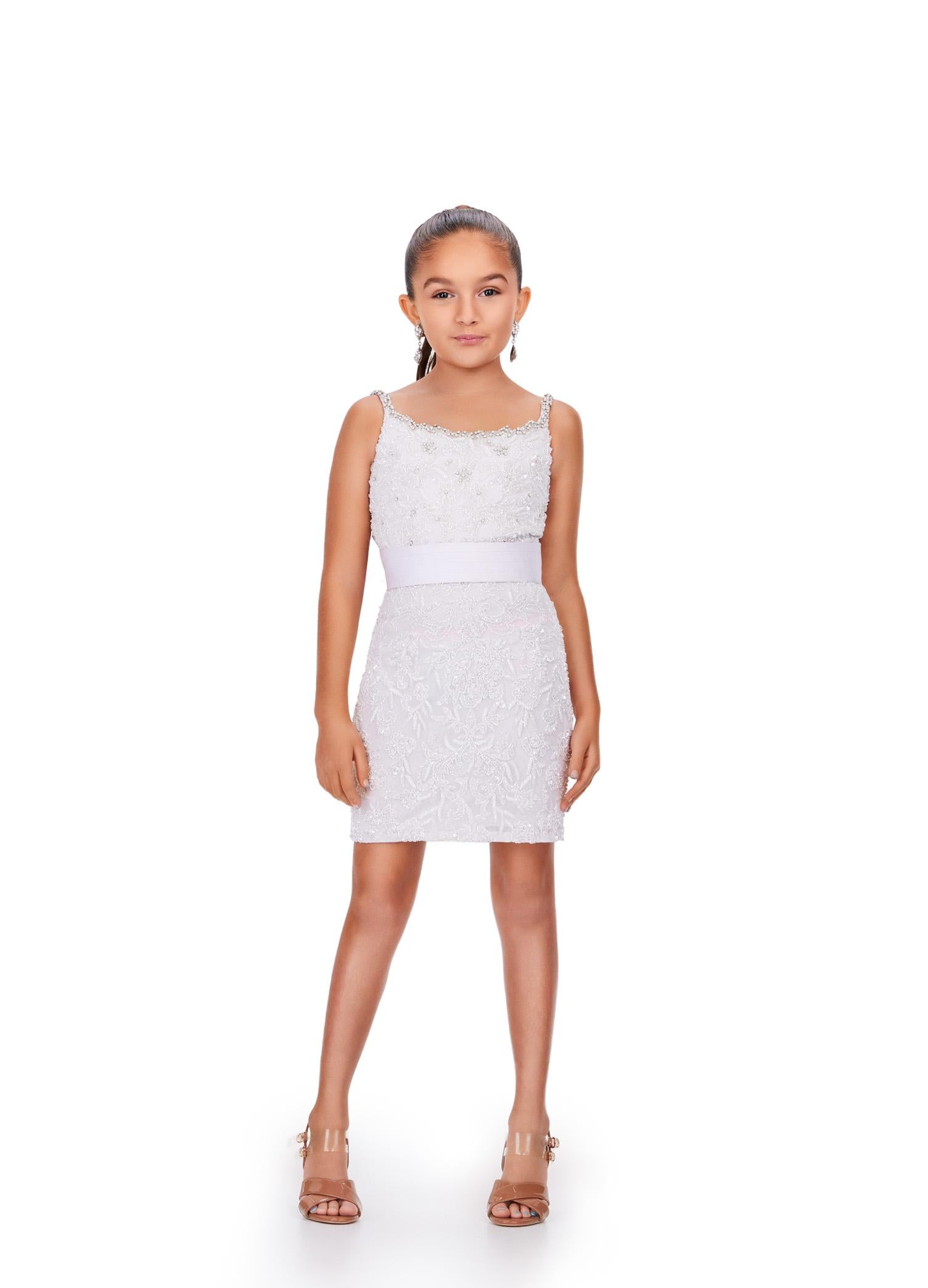 White ASHLEYlauren 8230 fully beaded fitted kids cocktail dress featuring delicate spaghetti straps, an oversized removable bow, and extra jewel embellishments along the neckline for a glamorous and fun look.