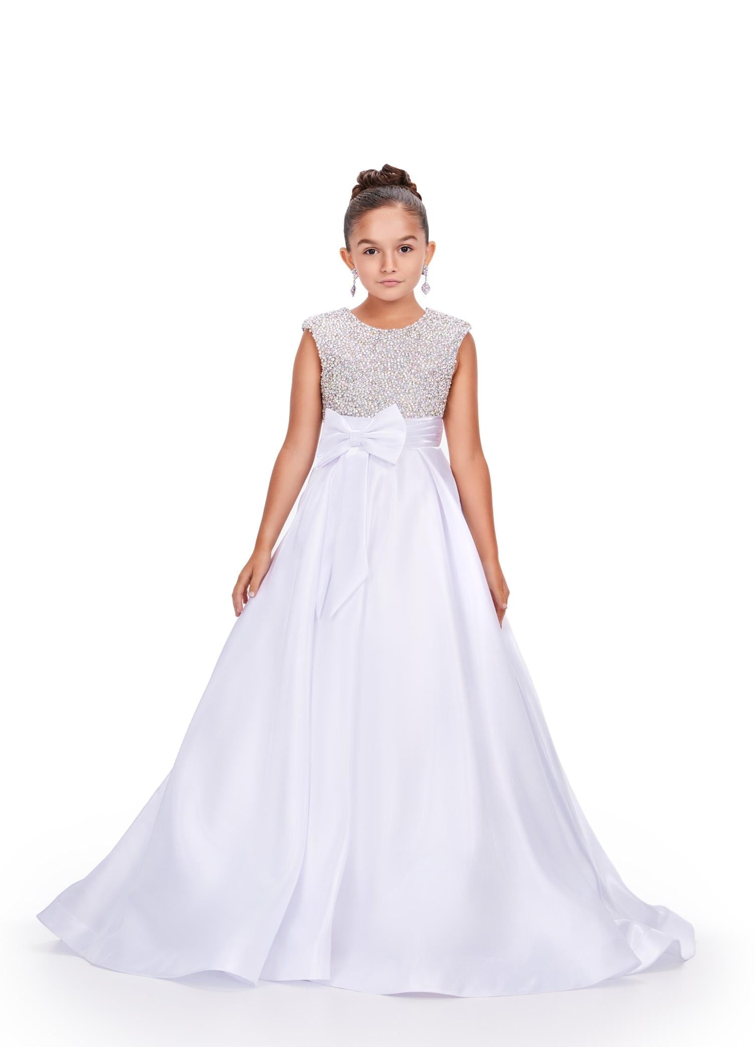 White ASHLEYlauren 8247 adorable kids ball gown featuring a fully embellished cap sleeve bodice, ruched waistline, and a full satin skirt accented with a bow for a charming and elegant look.