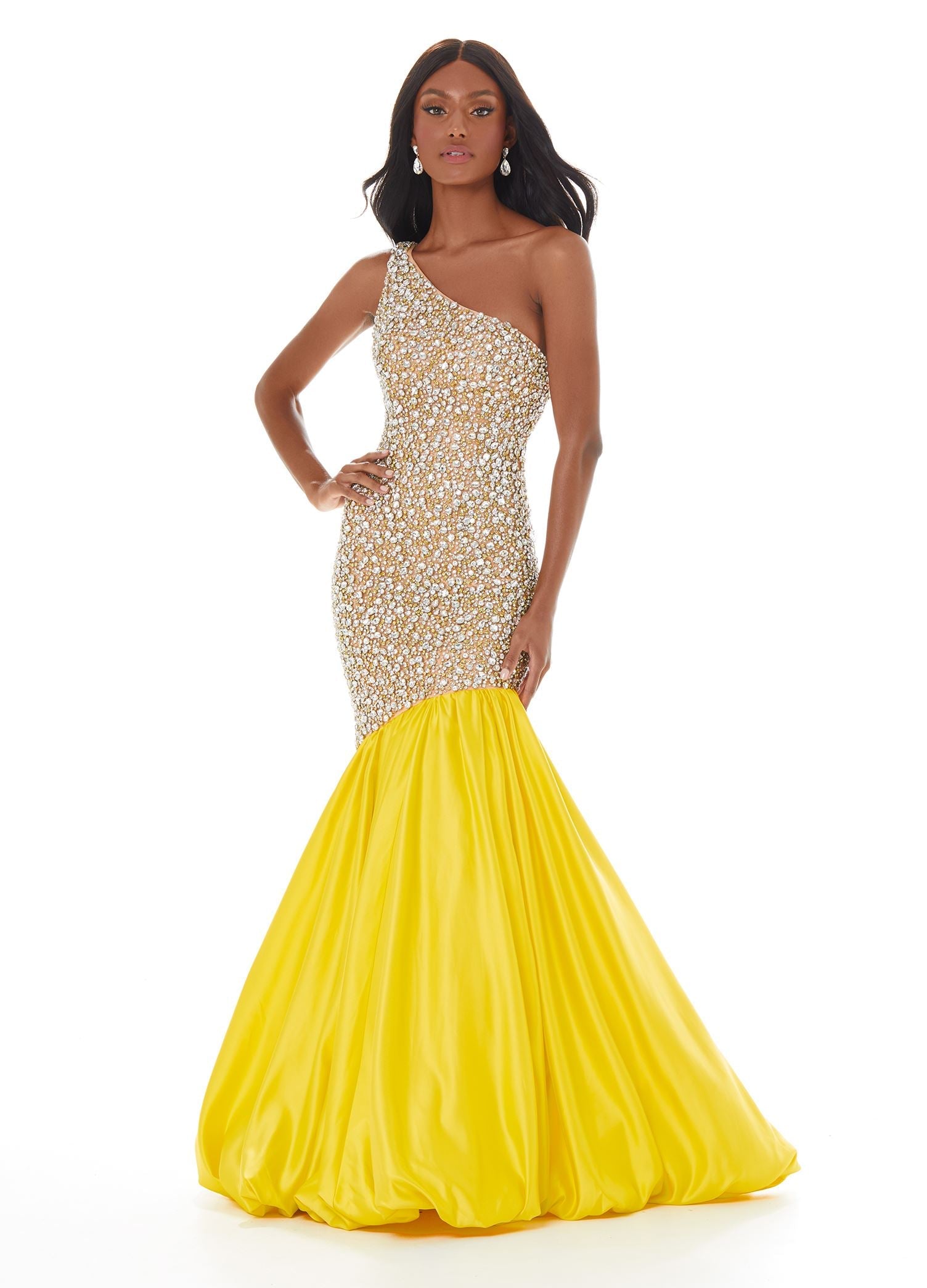 Yellow  ASHLEYlauren 1981 – A stunning one-shoulder fit and flare gown featuring a fully crystal and pearl beaded bodice, accented by an asymmetrical satin drop skirt with a dramatic bubble hem. Perfect for making a show-stopping statement.