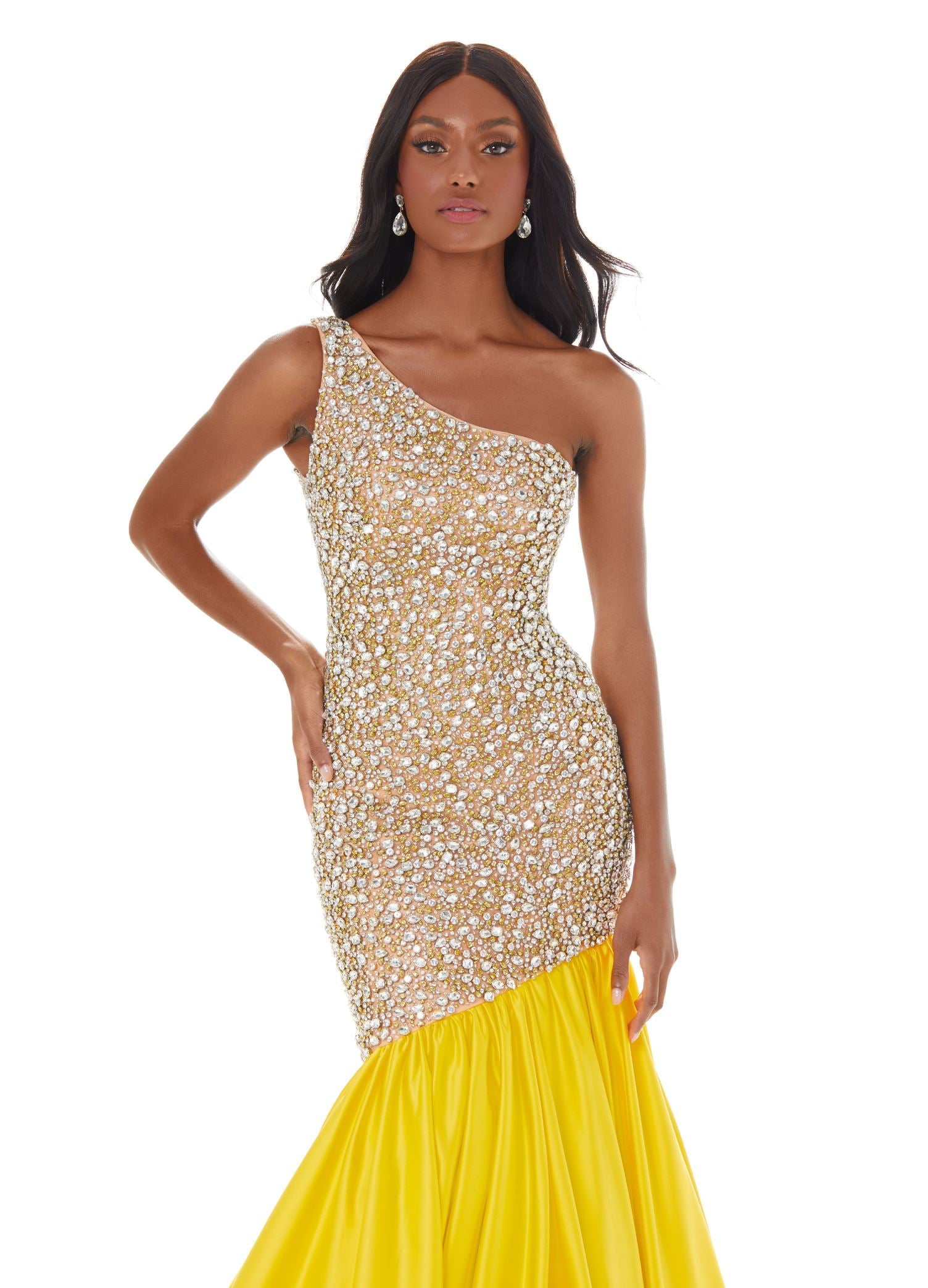  ASHLEYlauren 1981 – A stunning one-shoulder fit and flare gown featuring a fully crystal and pearl beaded bodice, accented by an asymmetrical satin drop skirt with a dramatic bubble hem. Perfect for making a show-stopping statement.