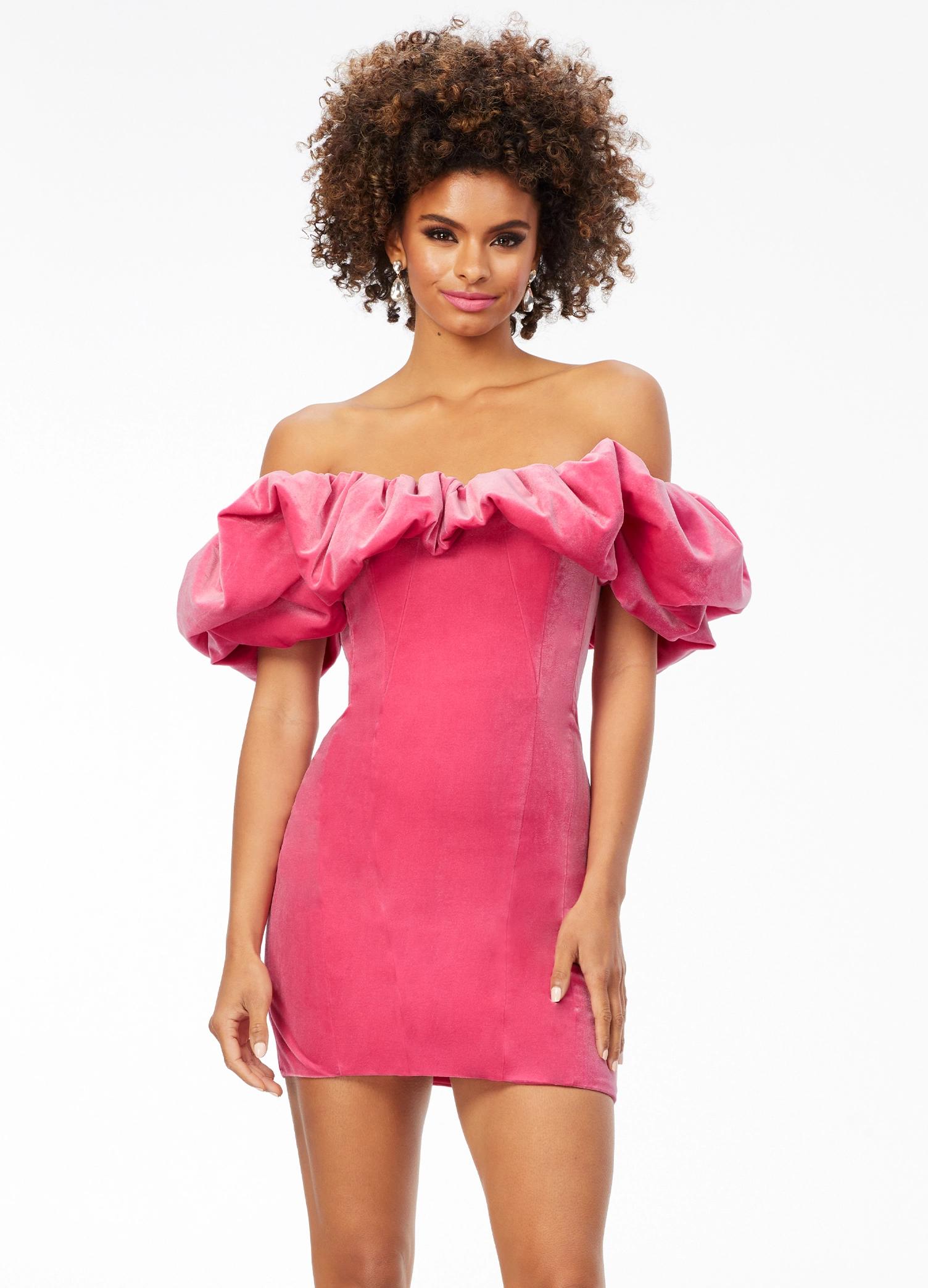 Pink ASHLEYlauren 4528 off shoulder stretch velvet cocktail dress featuring an oversized ruffle detail and contoured seaming throughout the fitted skirt for a chic, curve-enhancing look.