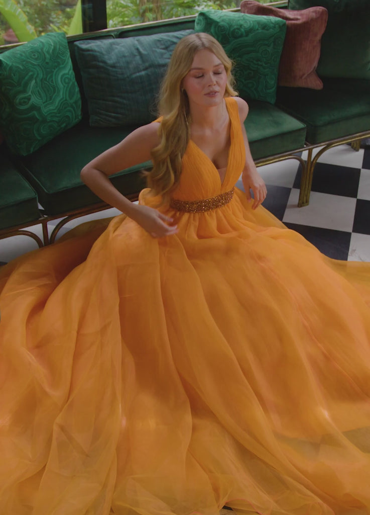 Video - Orange ASHLEYlauren 11305 stunning organza ball gown featuring a deep V-neckline, V-back, crystal-encrusted waistband, and a long, lavish train for an elegant and show-stopping look.