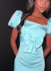 ASHLEYlauren 4955 | Blue crepe mini dress with puff sleeves, square neckline, and dramatic front bow detail