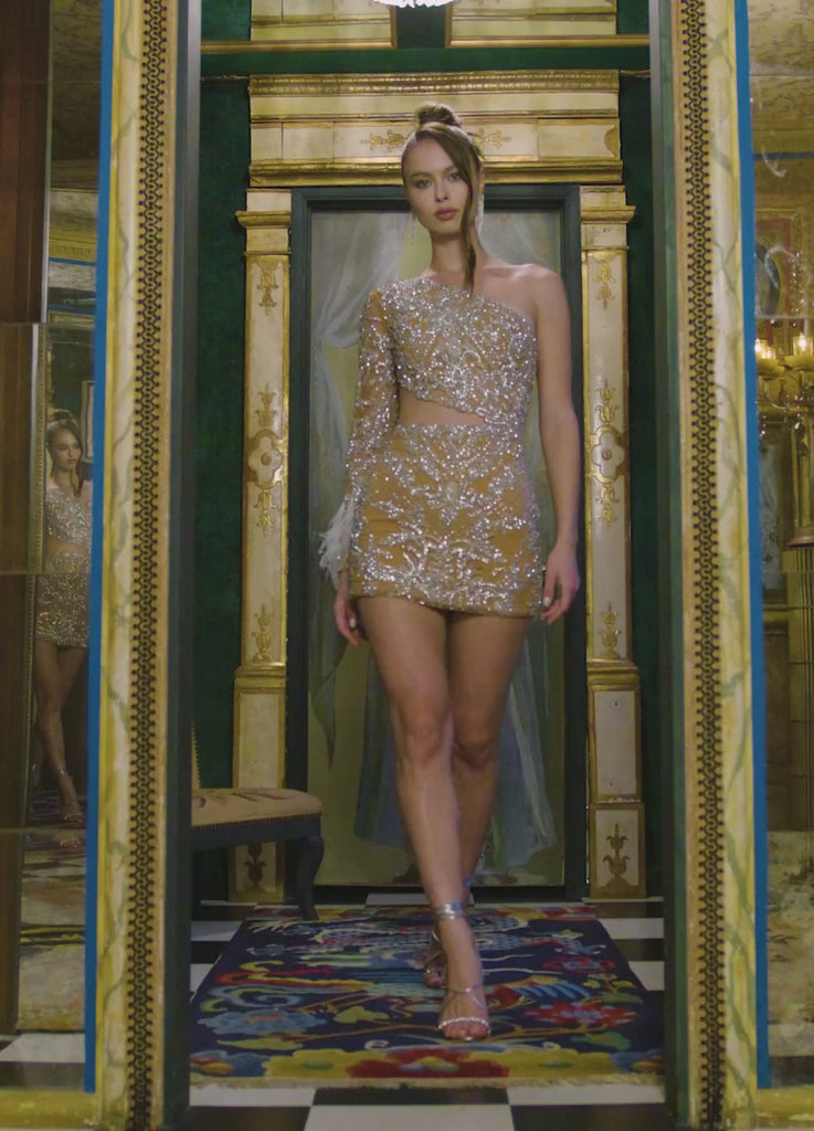Video -ASHLEYlauren 4565 fully beaded cocktail dress featuring a one sleeve design, modern waist cut-out, and feather accents at the wrist for a bold and glamorous look.